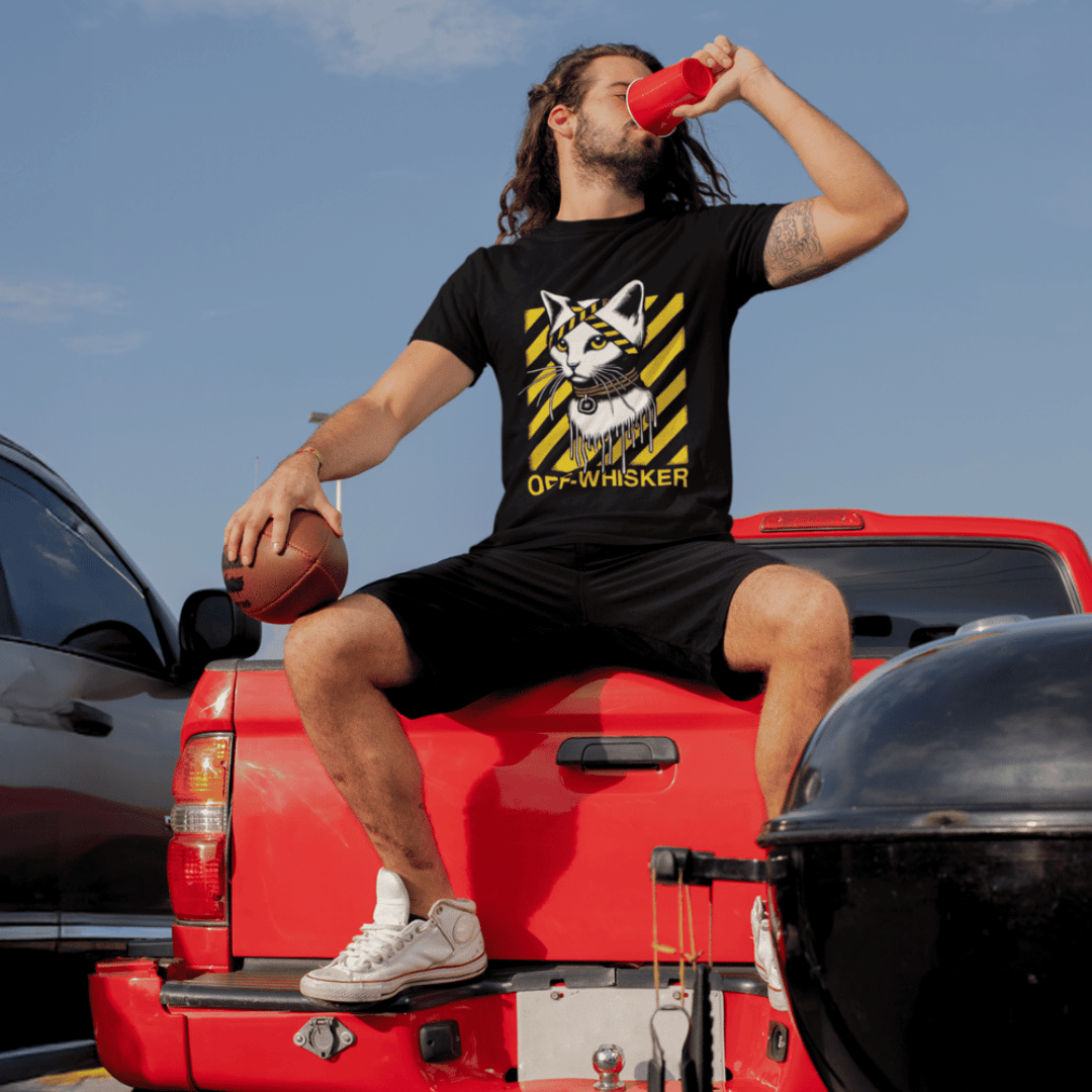 man wearing Cat On A Shirt, designer parody tee, sitting on a car and drinking from a cup and holding basketball ball
