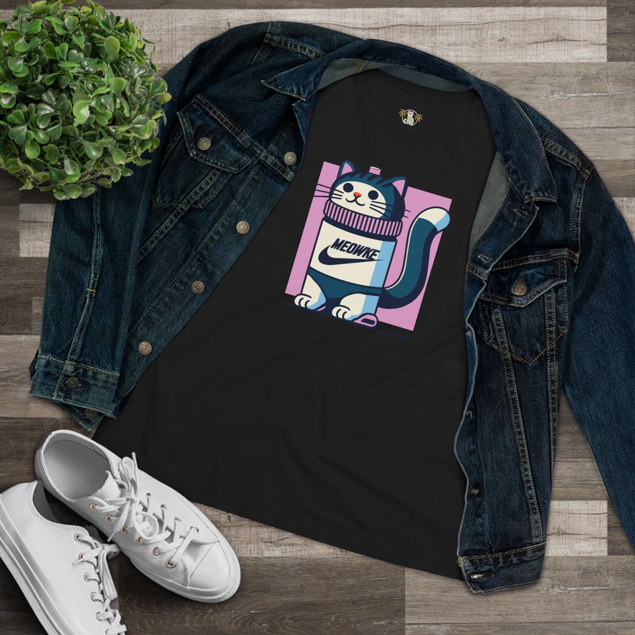 Flat lay black Meowke cat bottle graphic t shirt styled with denim jacket
