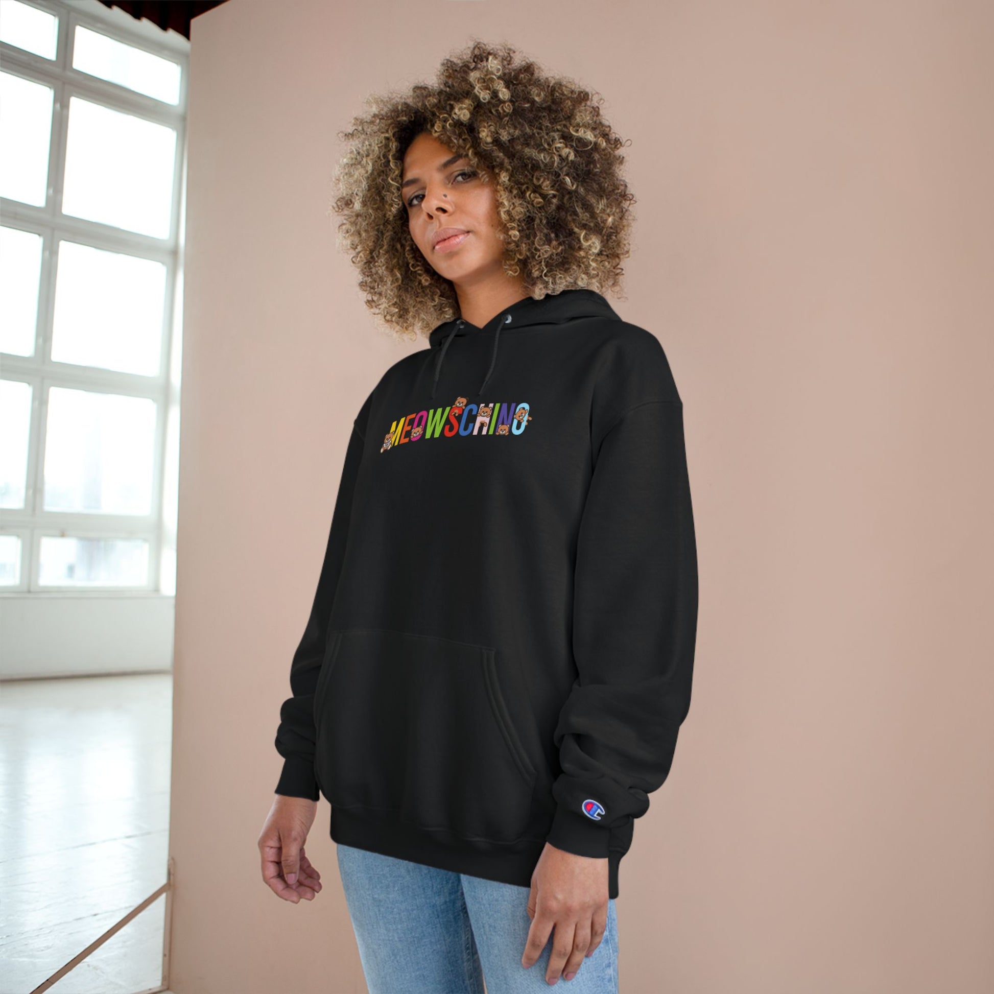Woman wearing Meowschino x Champion rainbow logo black hoodie, cat hoodies for women