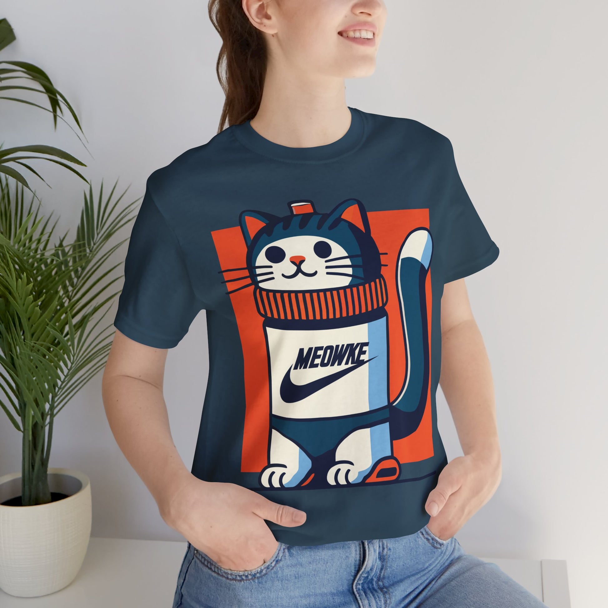 Funny cat t-shirt for women – deep teal unisex tee worn by female model, Meowke Swoosh cartoon cat bottle design