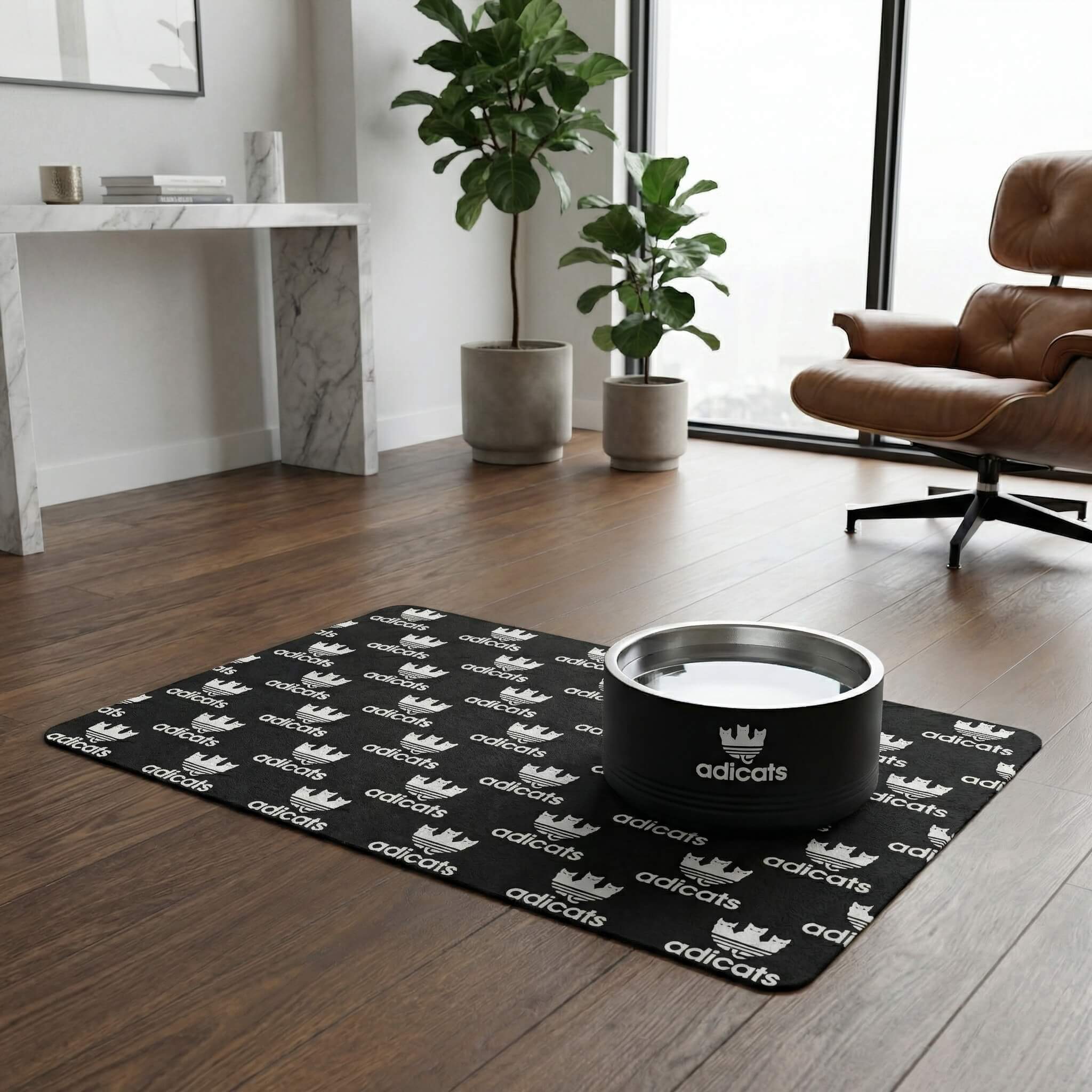 Adicats Logo Stainless Steel Cat Bowl in black, on the Adicats Repeat Logo Cat Feeding Mat