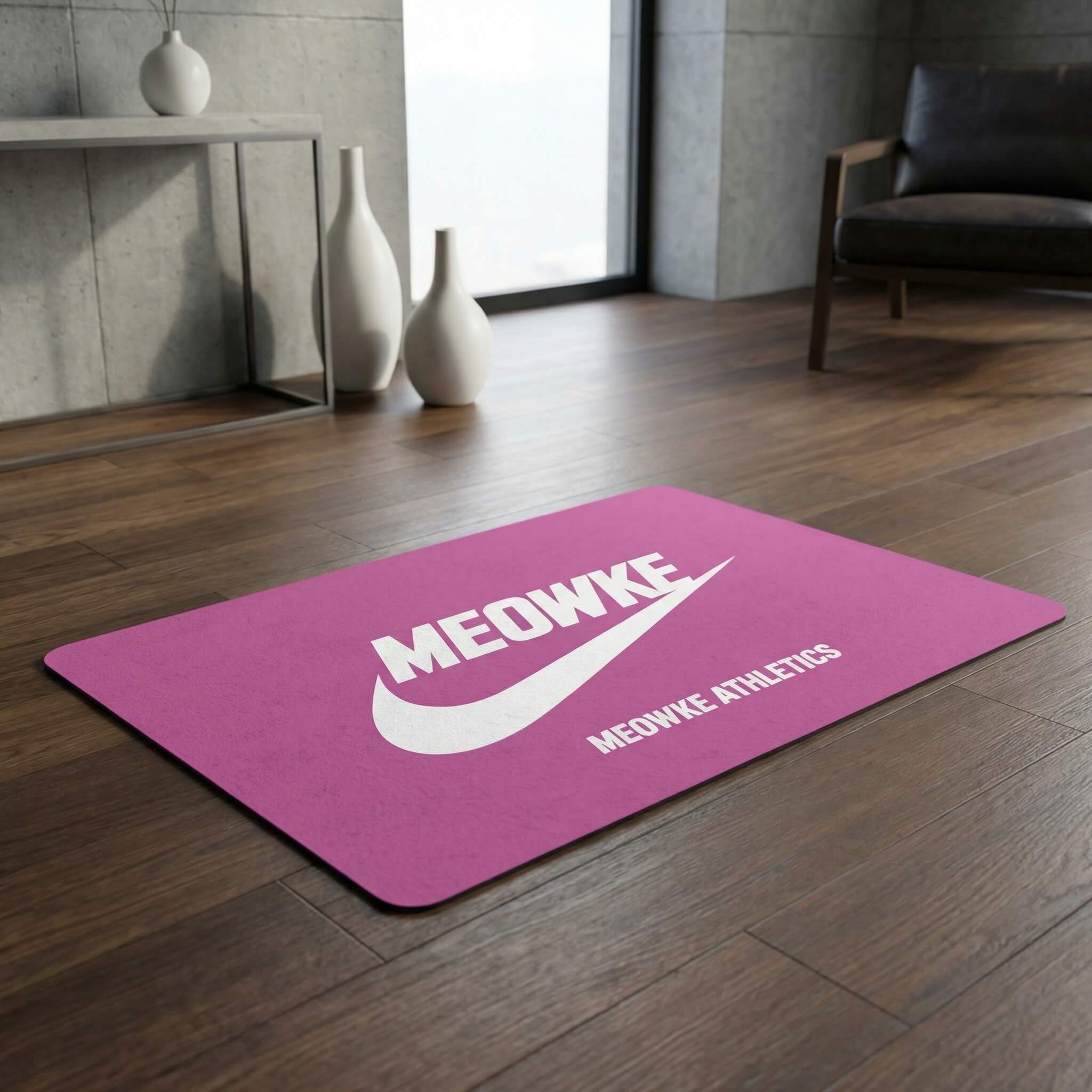 Meowke Athletics Designer Cat Feeding Mat in pink, in a home setting