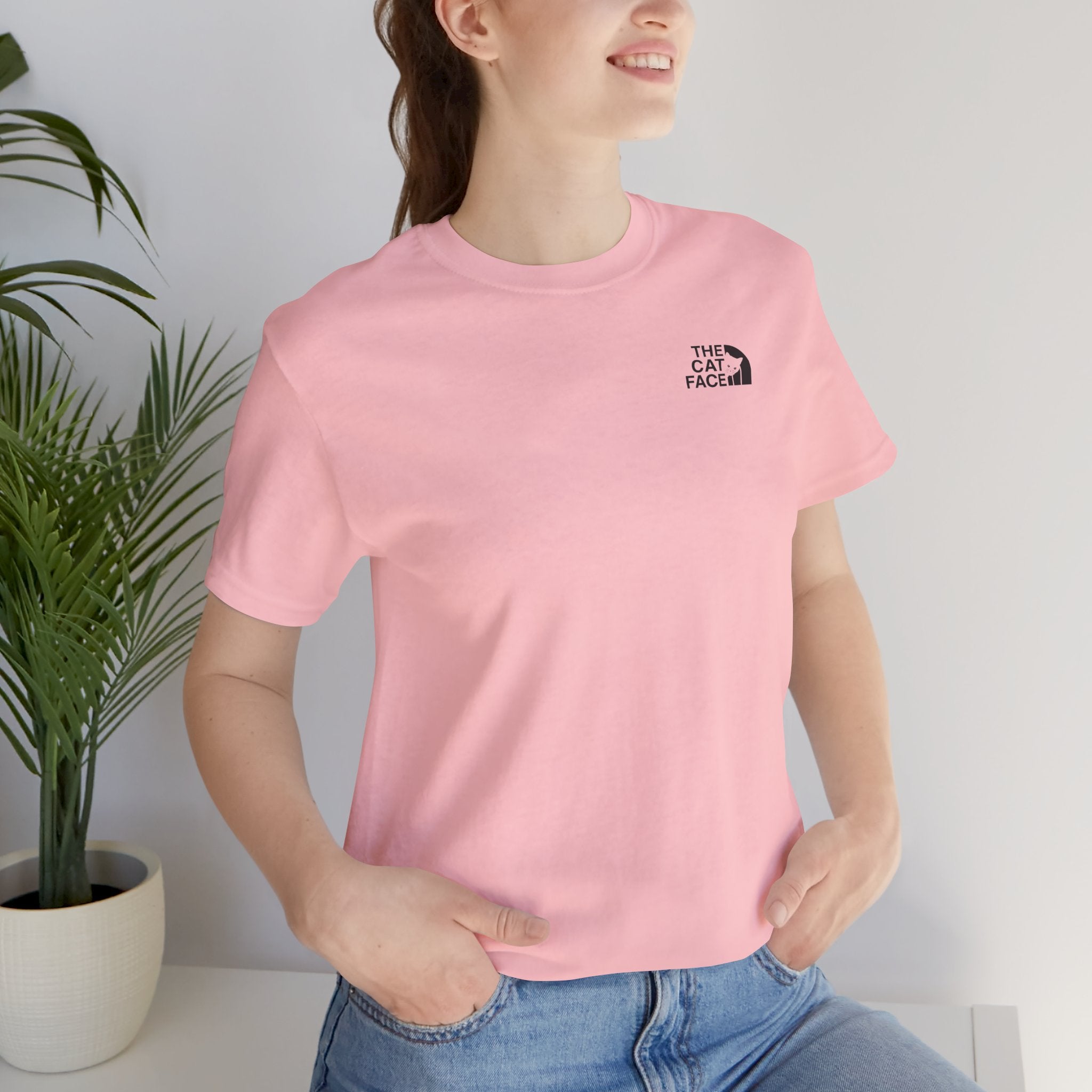 The Cat Face Classic Mini Chest Logo T-Shirt in pink, worn by a female model