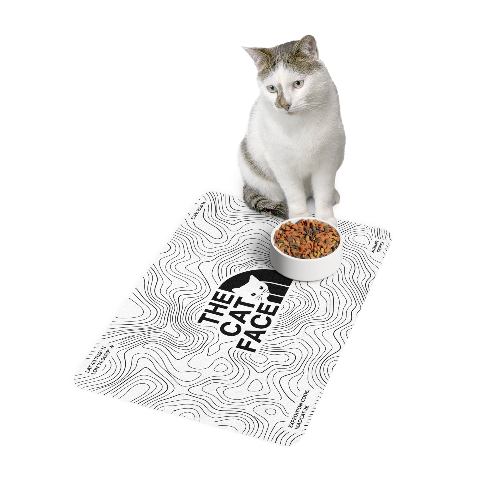 The Cat Face Summit Terrain Designer Cat Feeding Mat in white, with a cat