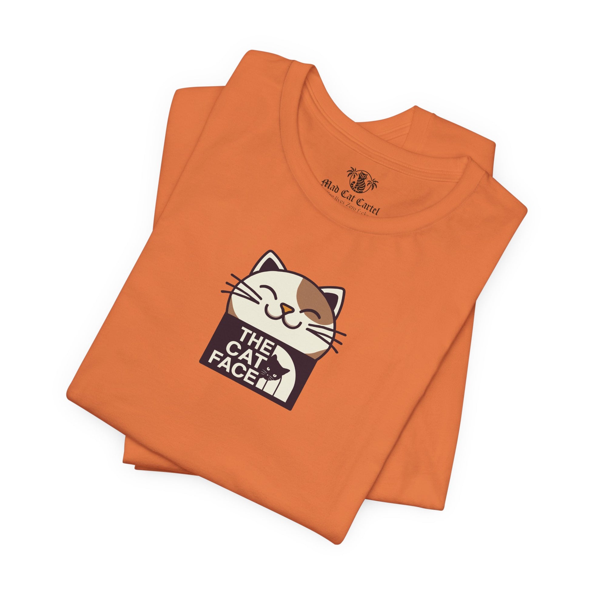 Cat face shirt burnt orange folded close up