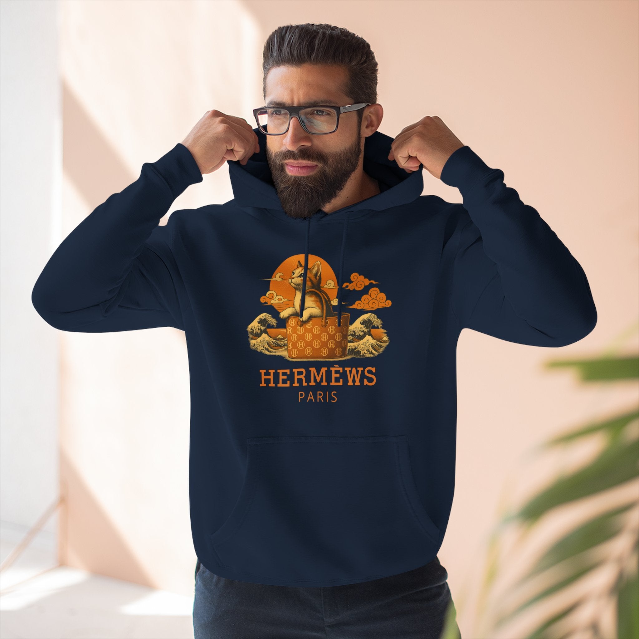 Man adjusting hood in Hermèws navy cat hoodie, mens hoodie for cat lovers