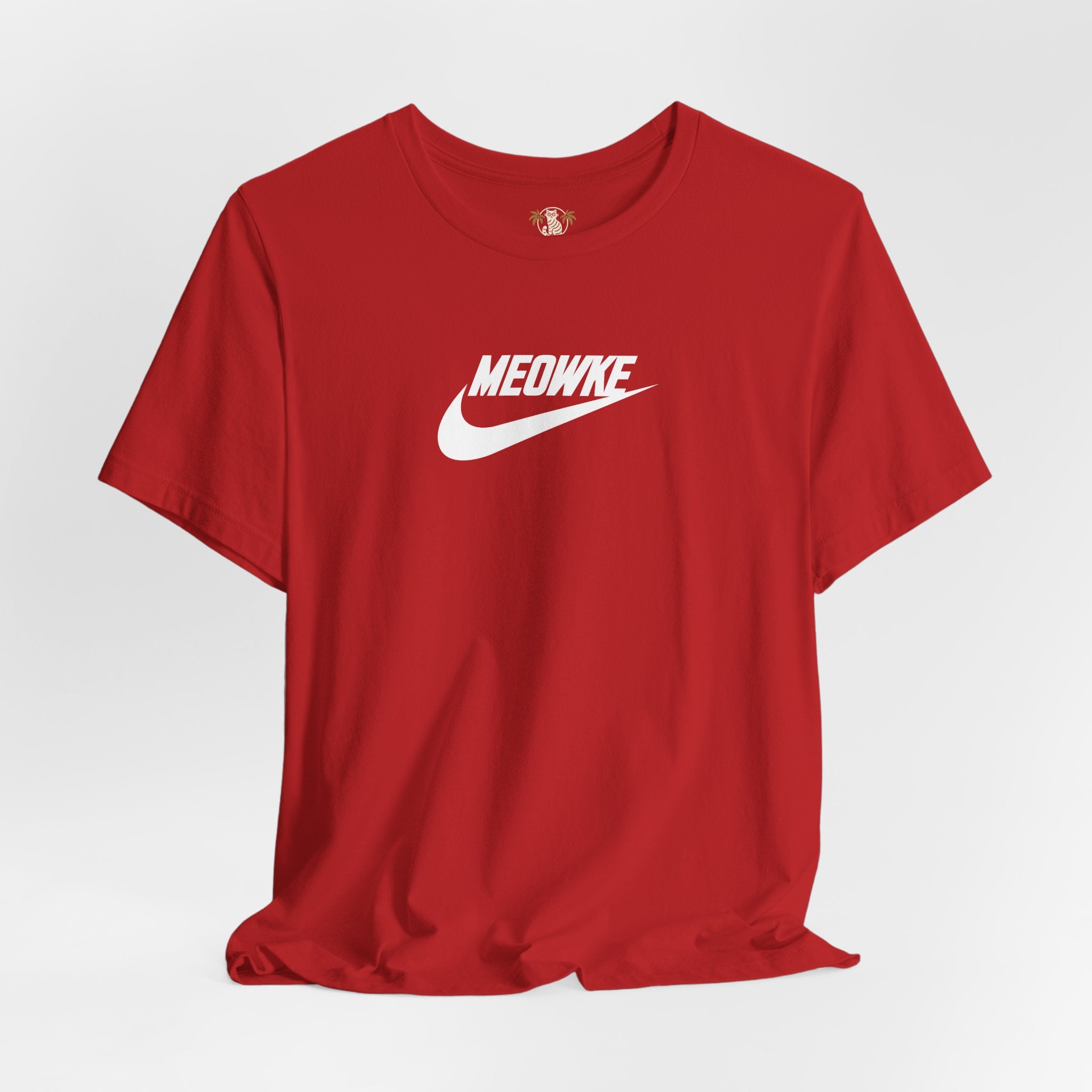 Funny t shirts for women – canvas red unisex tee, flat lay, white Meowke chest swoosh logo