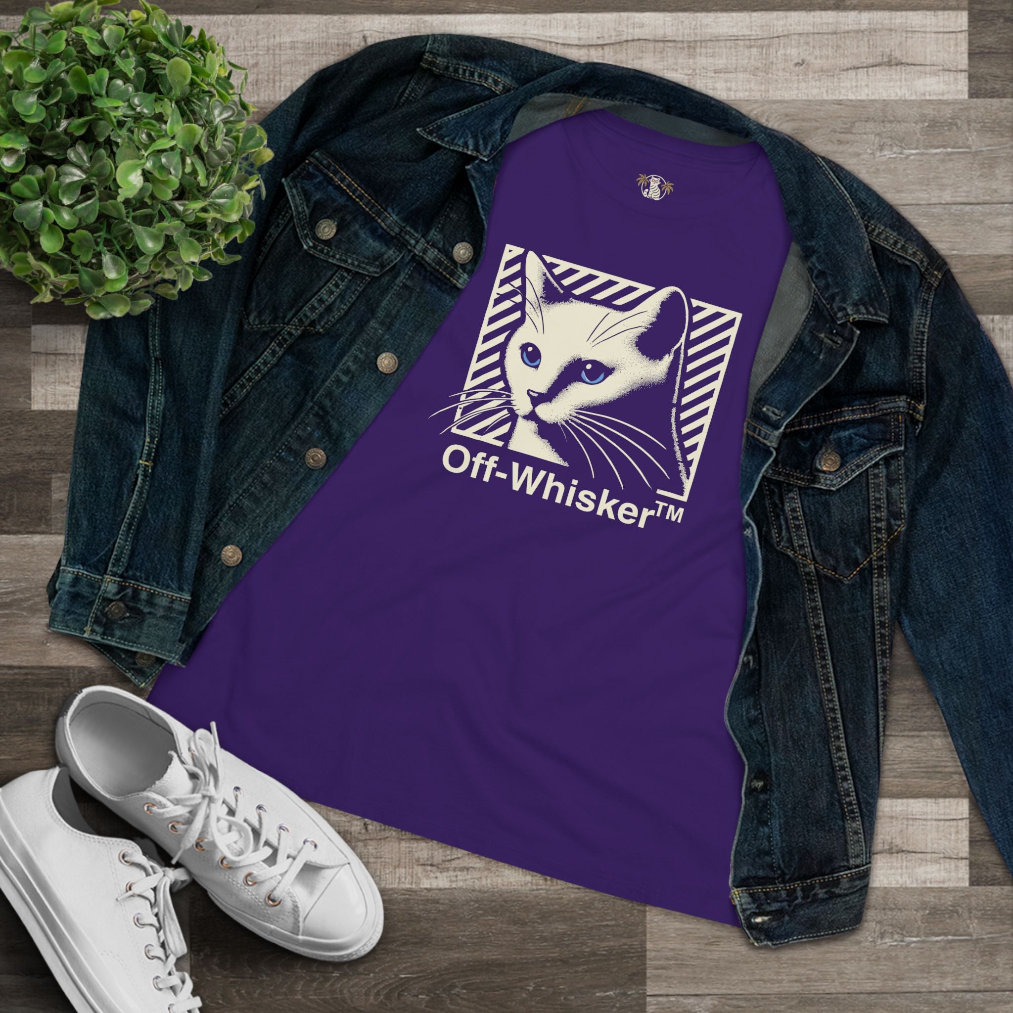 Off-Whisker Blue-Eyed Cat Graphic Women's T Shirt Team Purple, folded with denim jacket flatlay