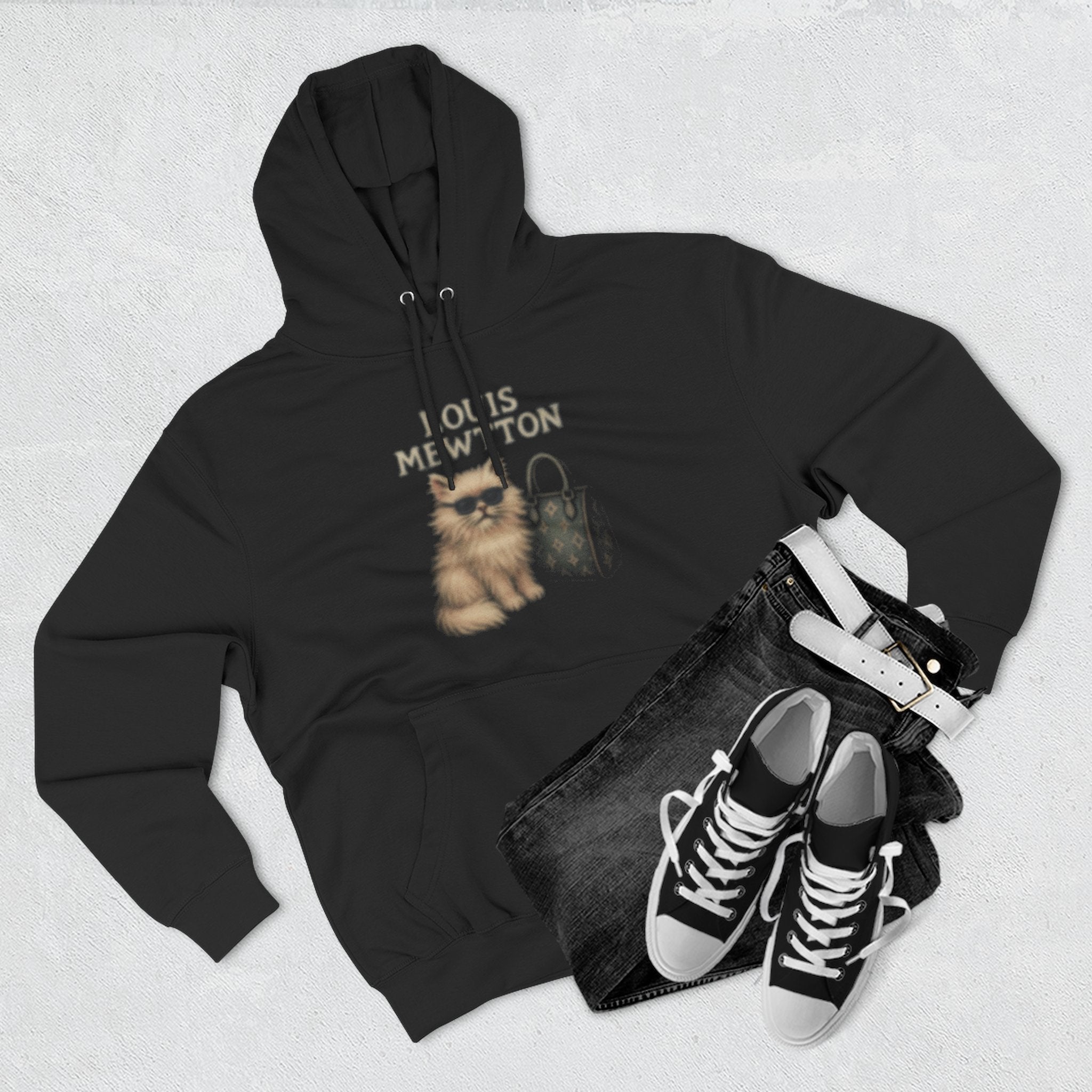 Flat lay of Louis Mewtton black hoodie with sneakers, things to get cat lovers