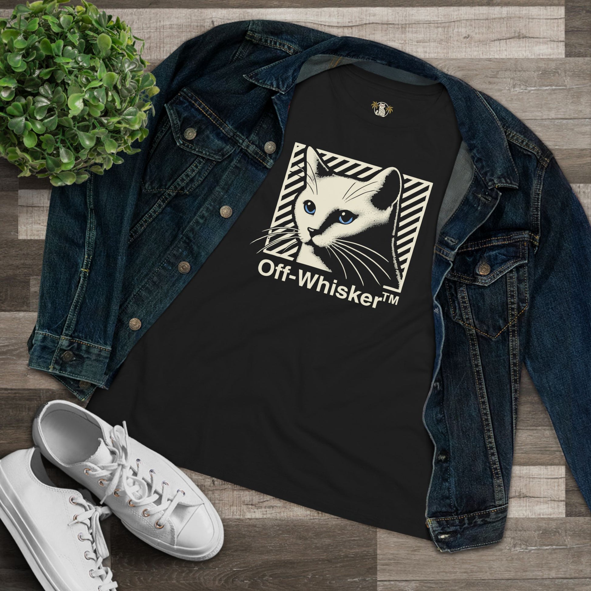 Off-Whisker Blue-Eyed Cat Graphic Women's T Shirt Black, folded with denim jacket flat lay
