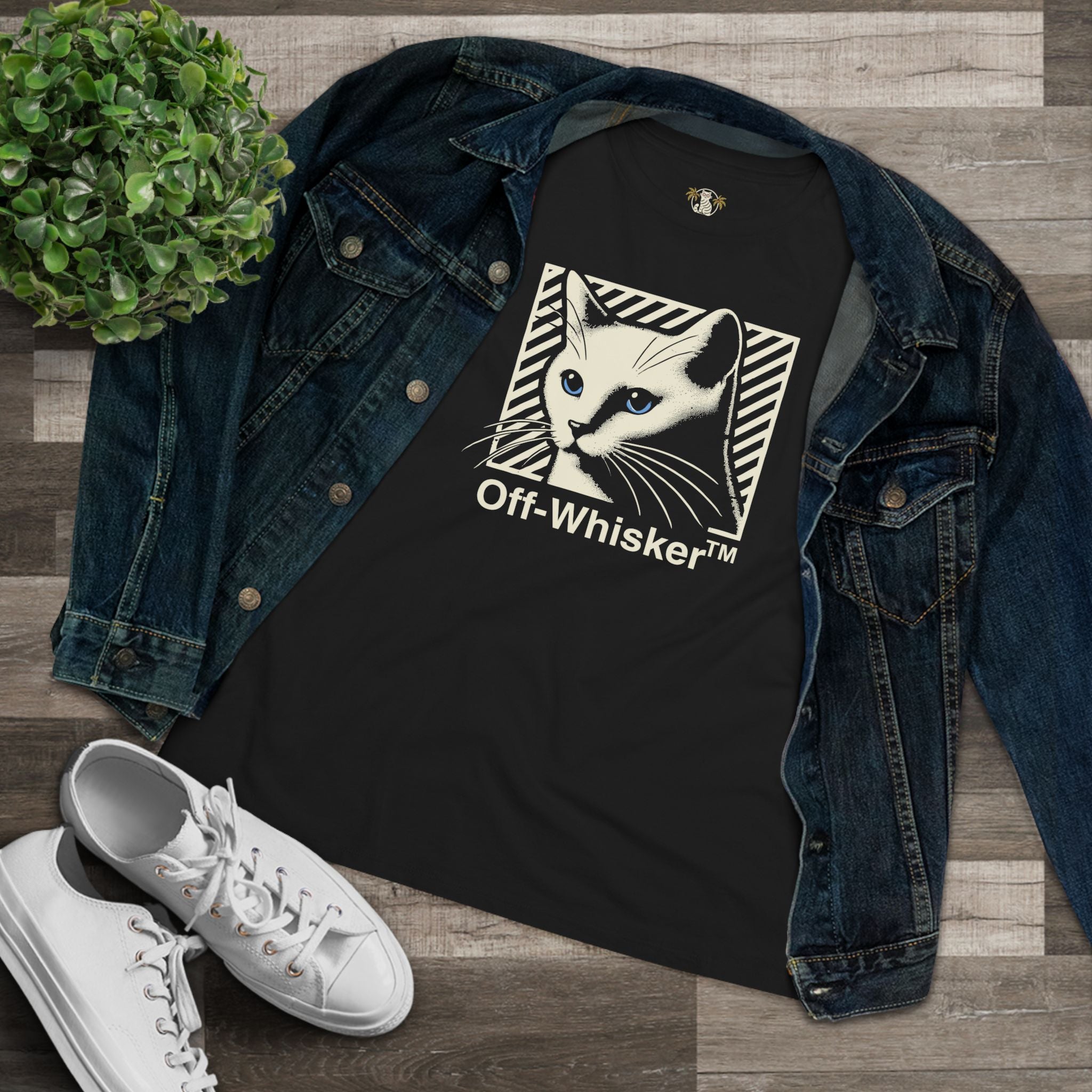 Off-Whisker Blue-Eyed Cat Graphic Women's T Shirt Black, folded with denim jacket flat lay