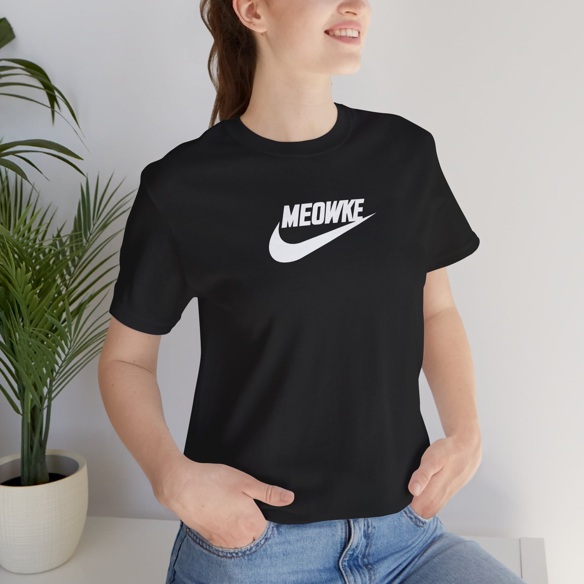 Funny t shirts for women – storm grey unisex tee worn by male model, black Meowke chest swoosh logo