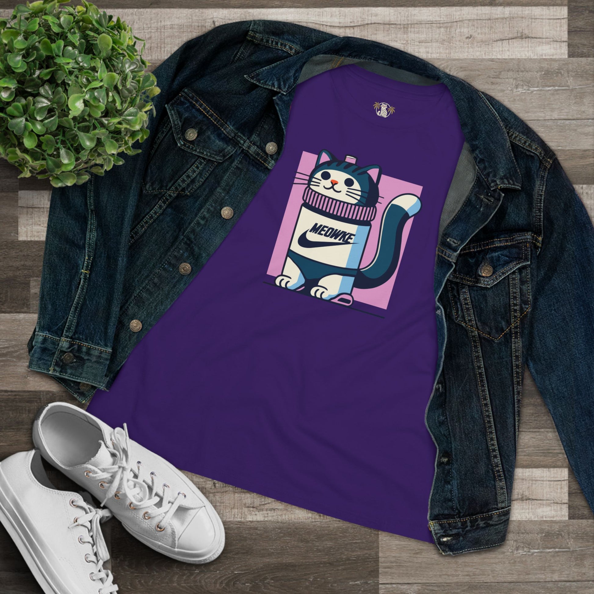 Flat lay purple women’s cat bottle graphic t shirt styled with denim jacket