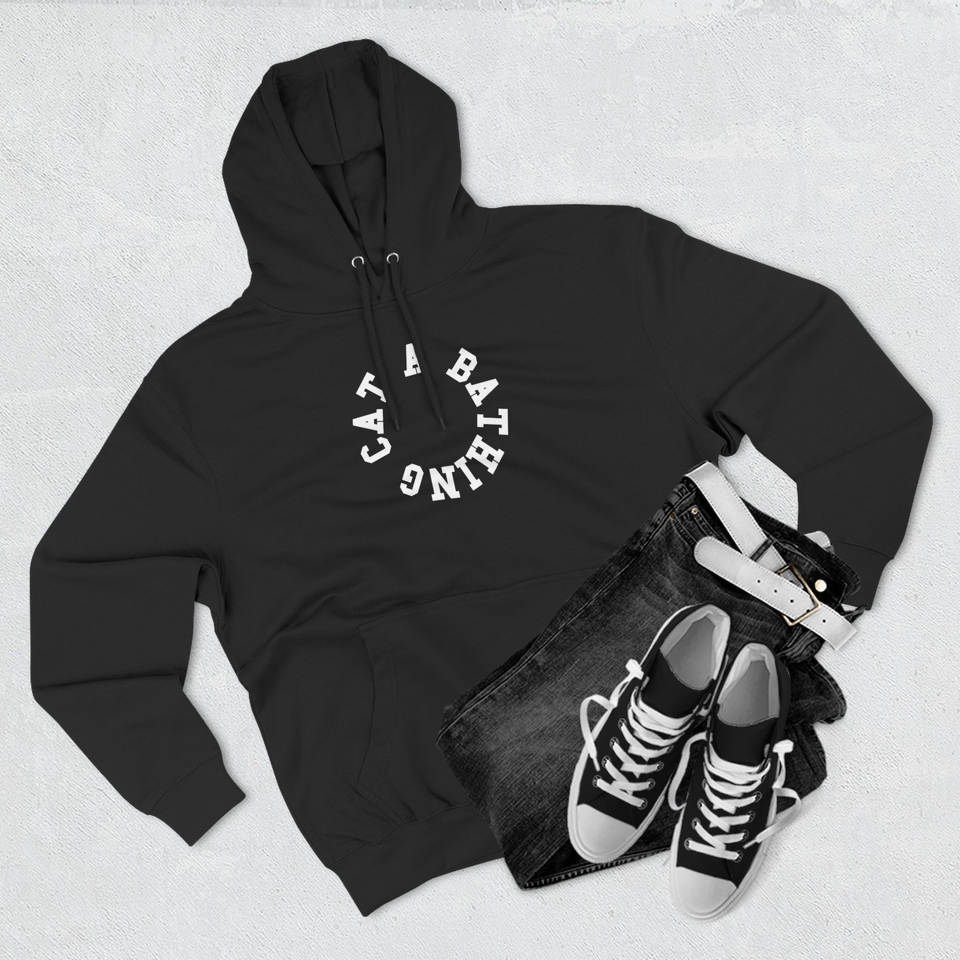 flat lay of black cat graphic hoodie with circle chest logo, cat themed clothing