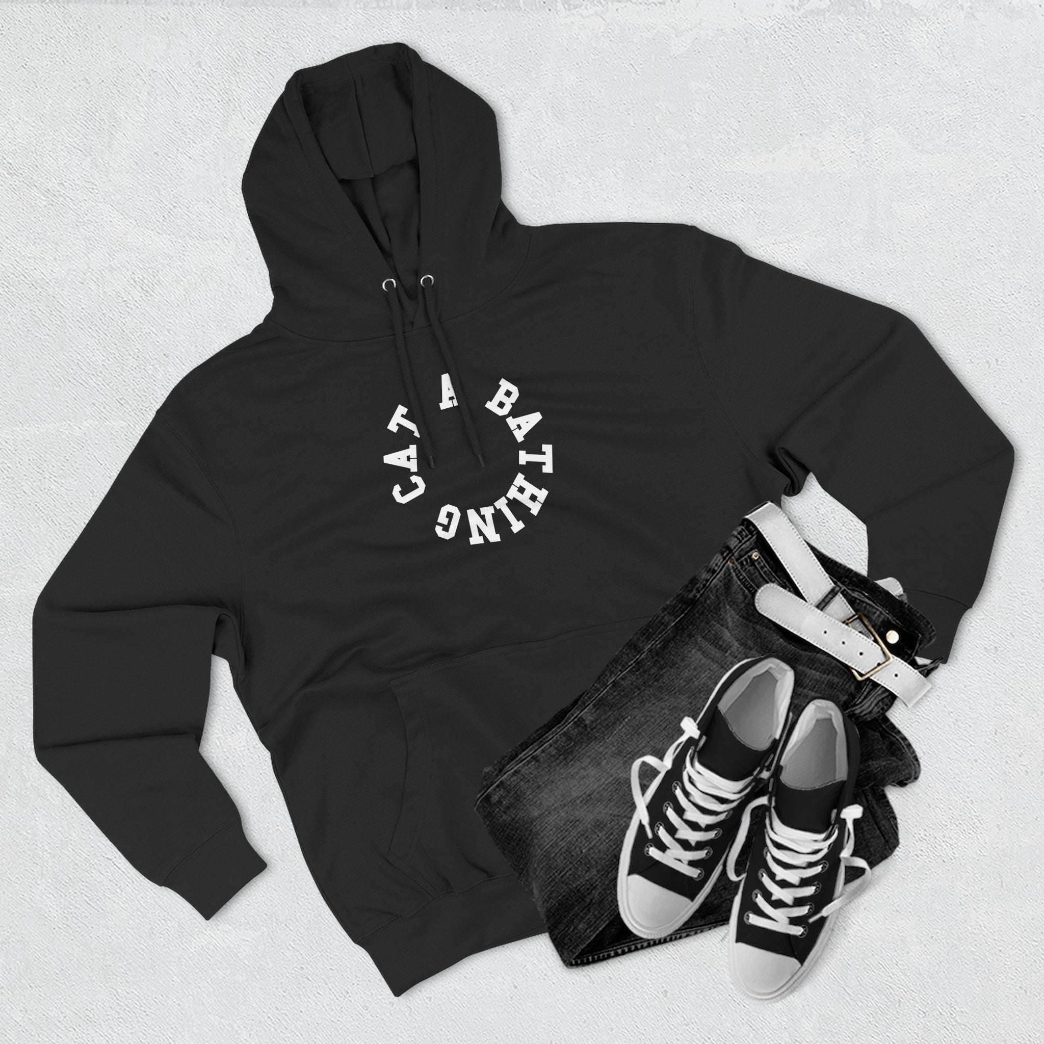 flat lay of black cat graphic hoodie with circle chest logo, cat themed clothing