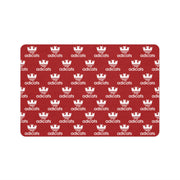 cat feeding red mat with white 'adicats' logo pattern on a white background