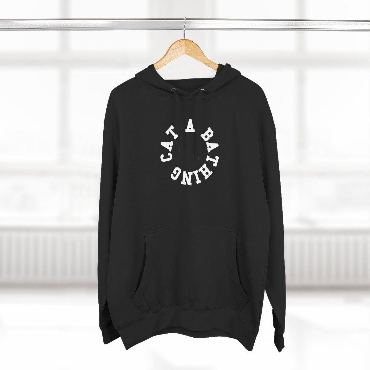 A Bathing Cat Circle Chest Logo Back Cat Graphic Print Black Hoodie, on a hanger