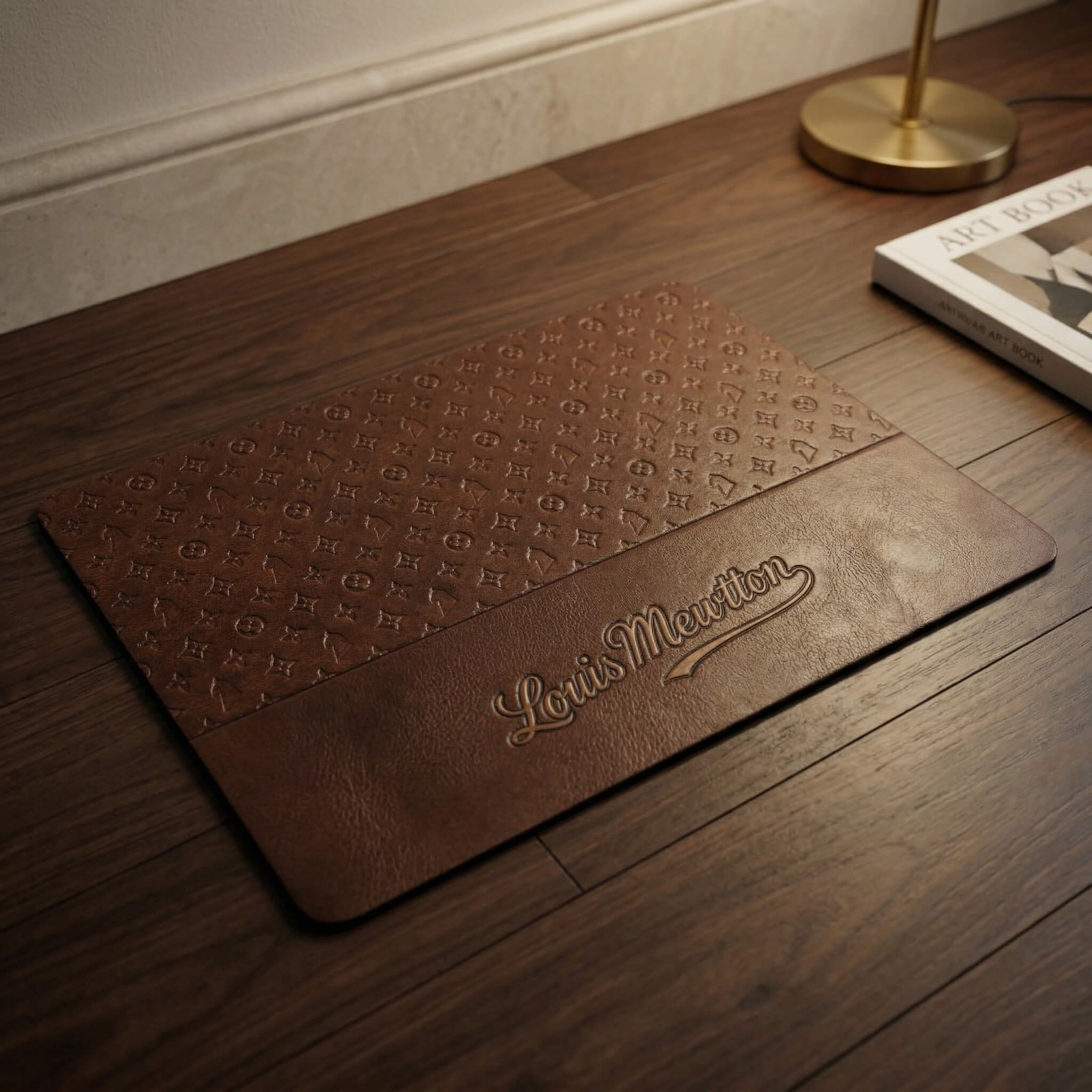 Brown cat feeding mat with Louis Mewtton monogram style print on wood floor