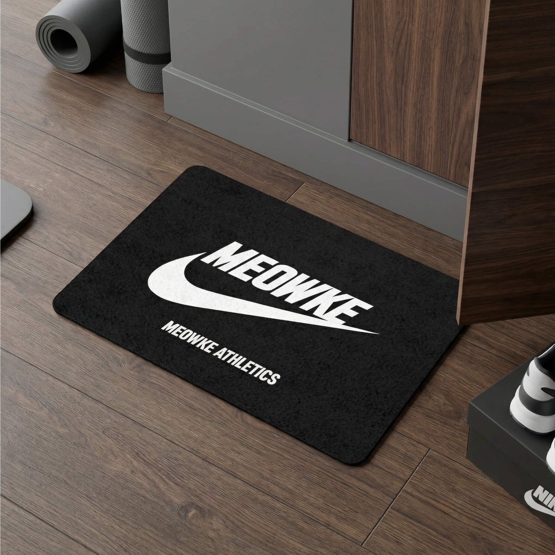 Meowke Athletics cat bowl mat in black on wood floor in a modern interior
