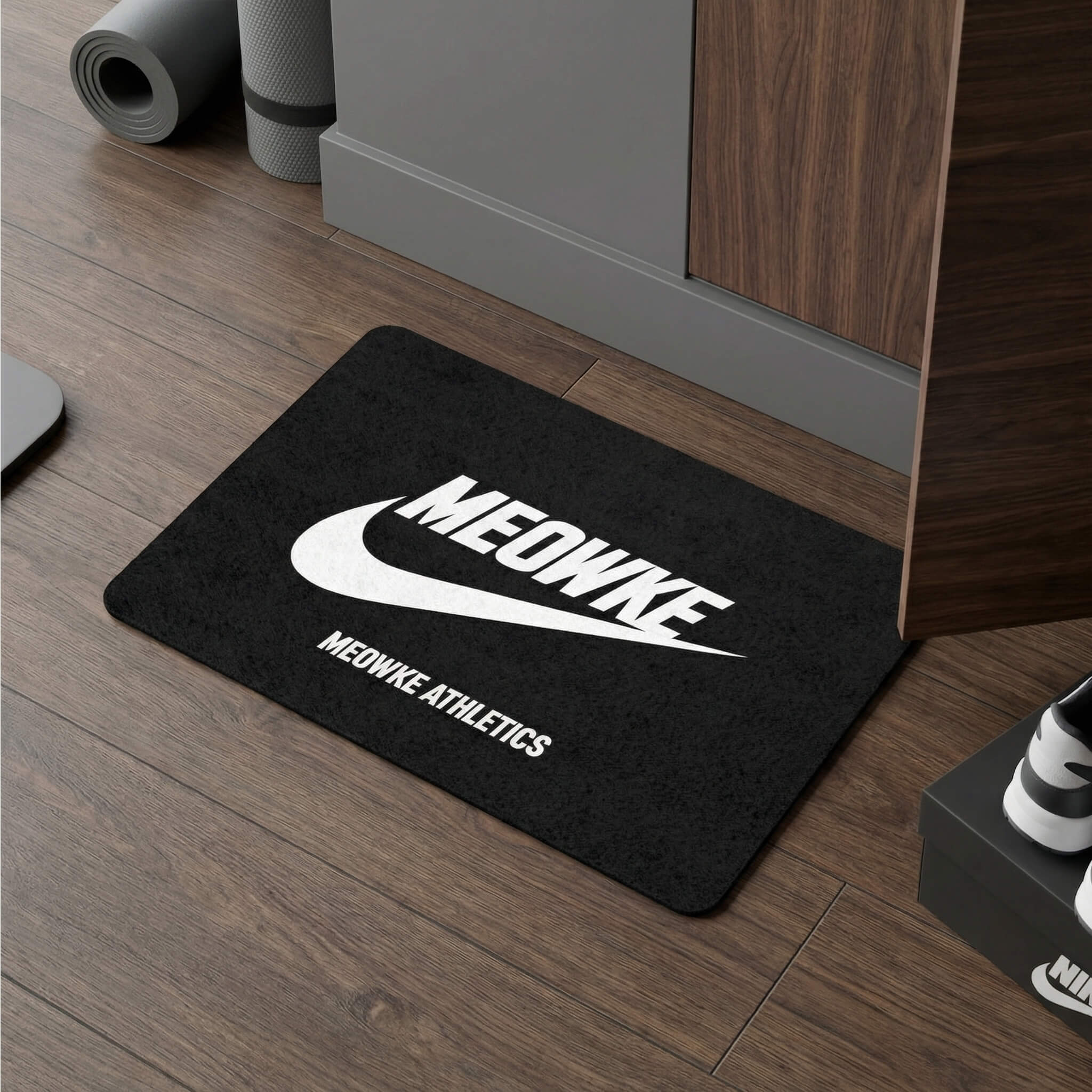 Meowke Athletics cat bowl mat in black on wood floor in a modern interior