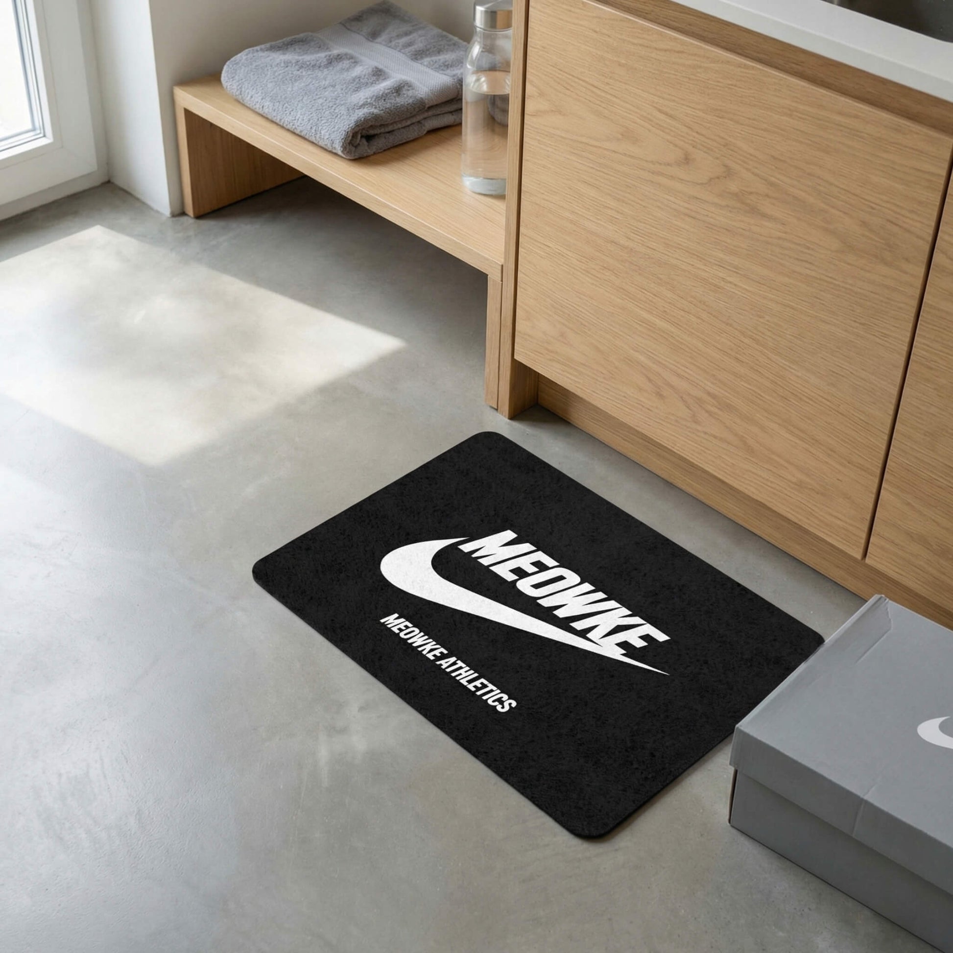 Meowke black cat mat with athletic branding placed near cabinet