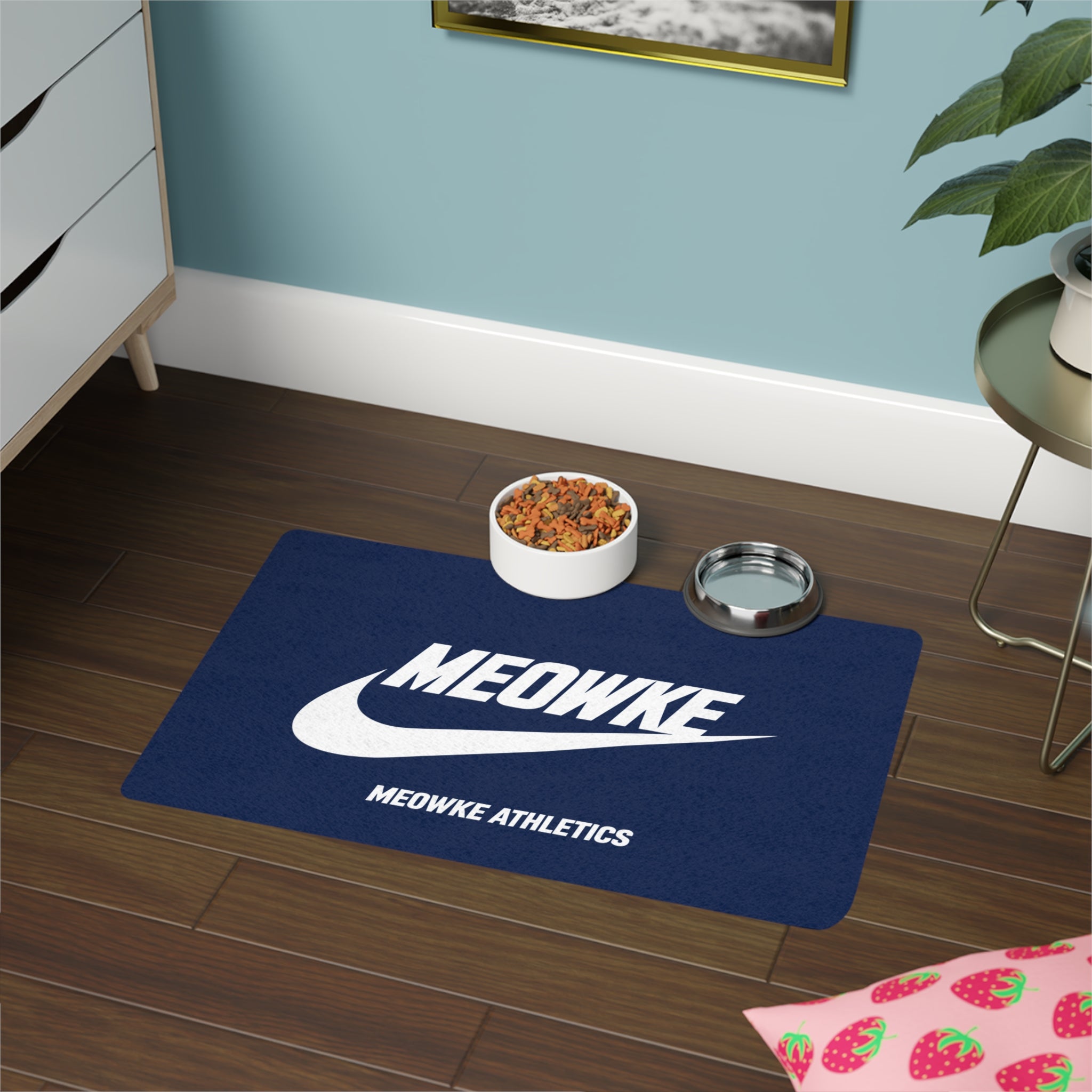 Meowke blue cat food mat with food and water bowls on a clean athletic logo layout