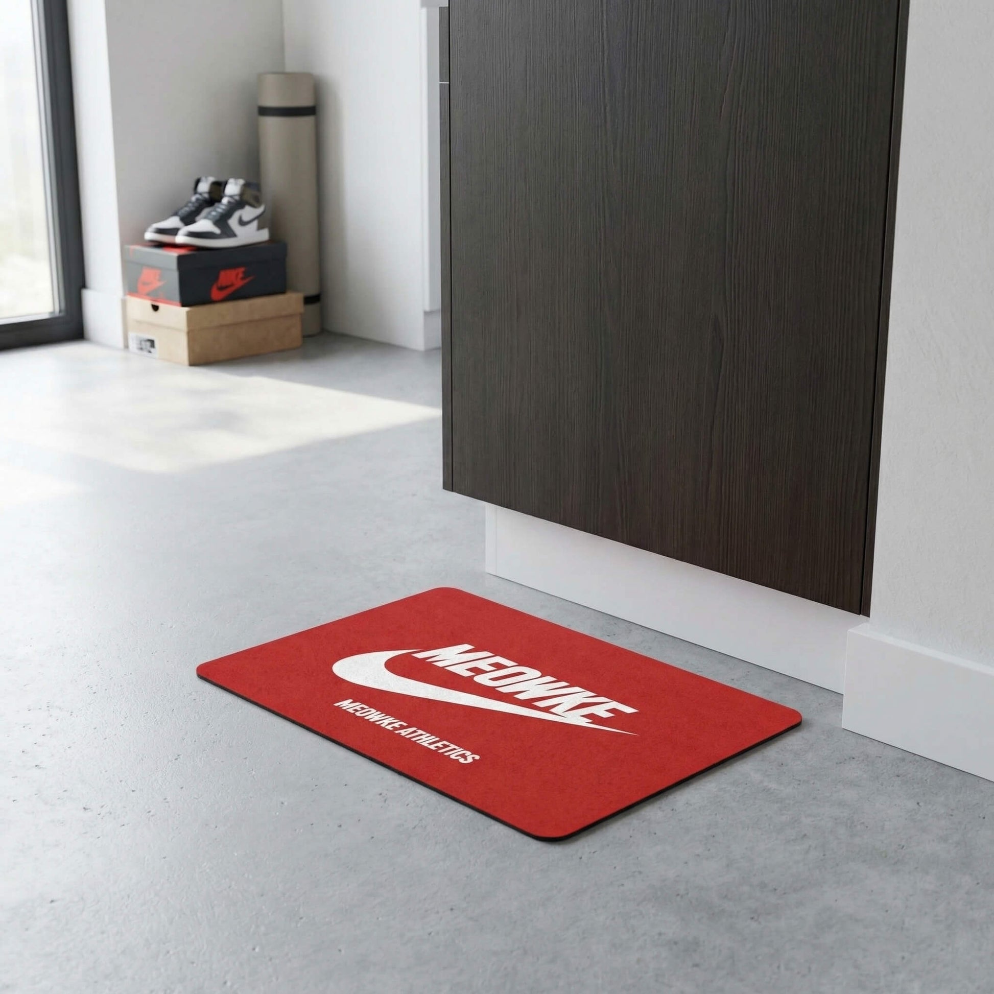Meowke Athletics cat bowl mat in red placed near cabinet on a bright floor