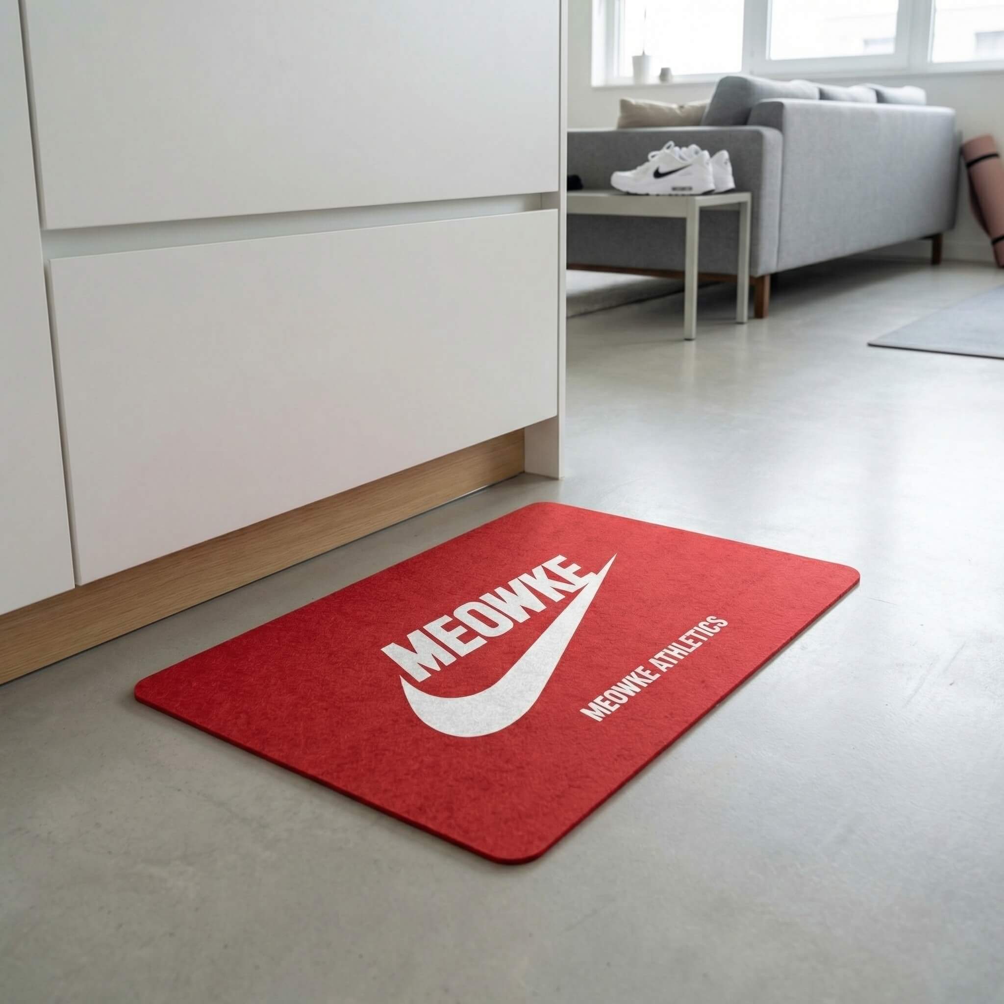 Red cat feeding mat with Meowke logo in a clean home setup