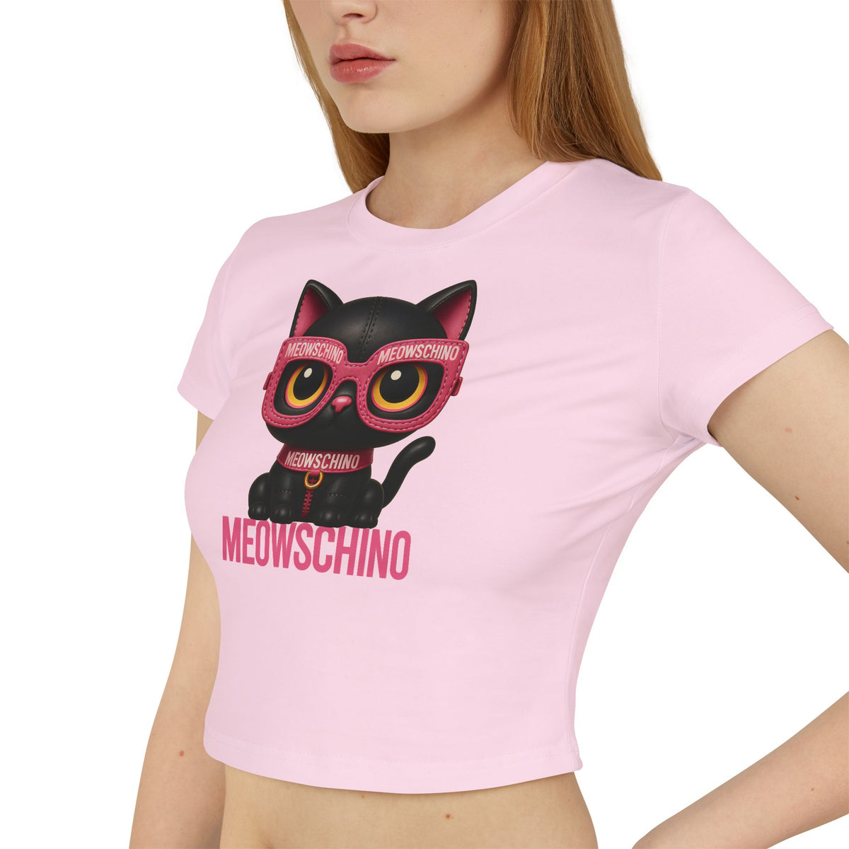 Meowschino Pink Leather Cat Graphic Women's Baby Tee in light pink, worn by a female model