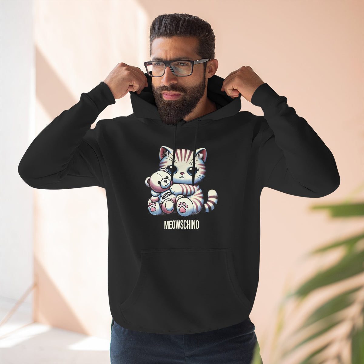 Meowschino Teddy Hug Cat Graphic Hoodie in black, worn by a male model