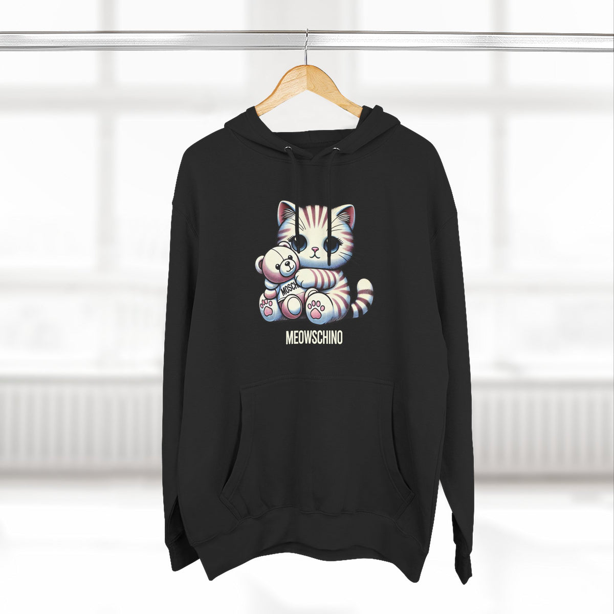 Meowschino Teddy Hug Cat Graphic Hoodie in black, on a hanger