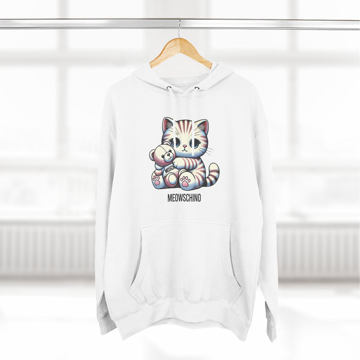 Meowschino Teddy Hug Cat Graphic Hoodie in white, on a hanger