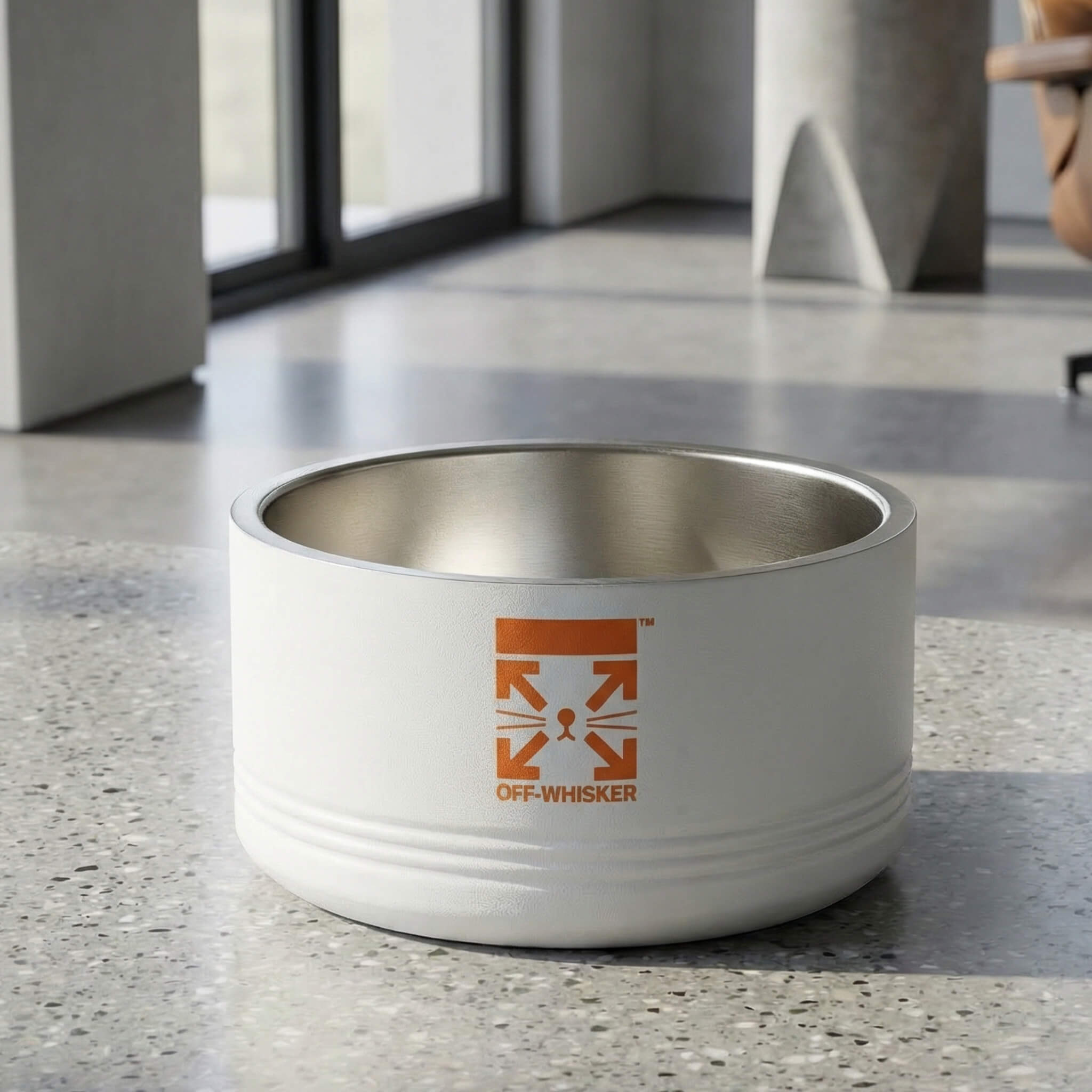 White designer stainless steel cat bowl with front off whisker logo in modern home