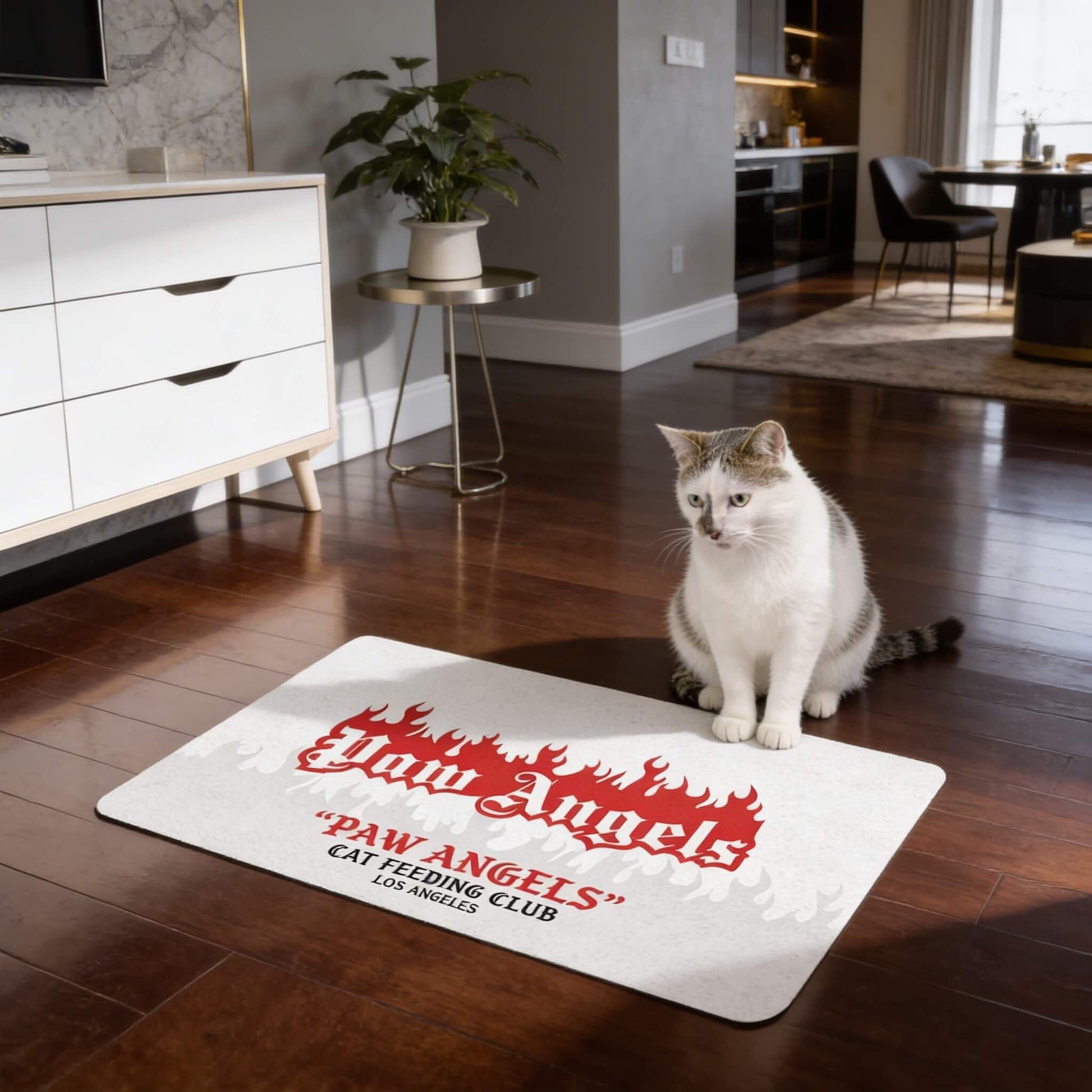 Paw Angels feeding station mat for cats with bold red graphic on white background