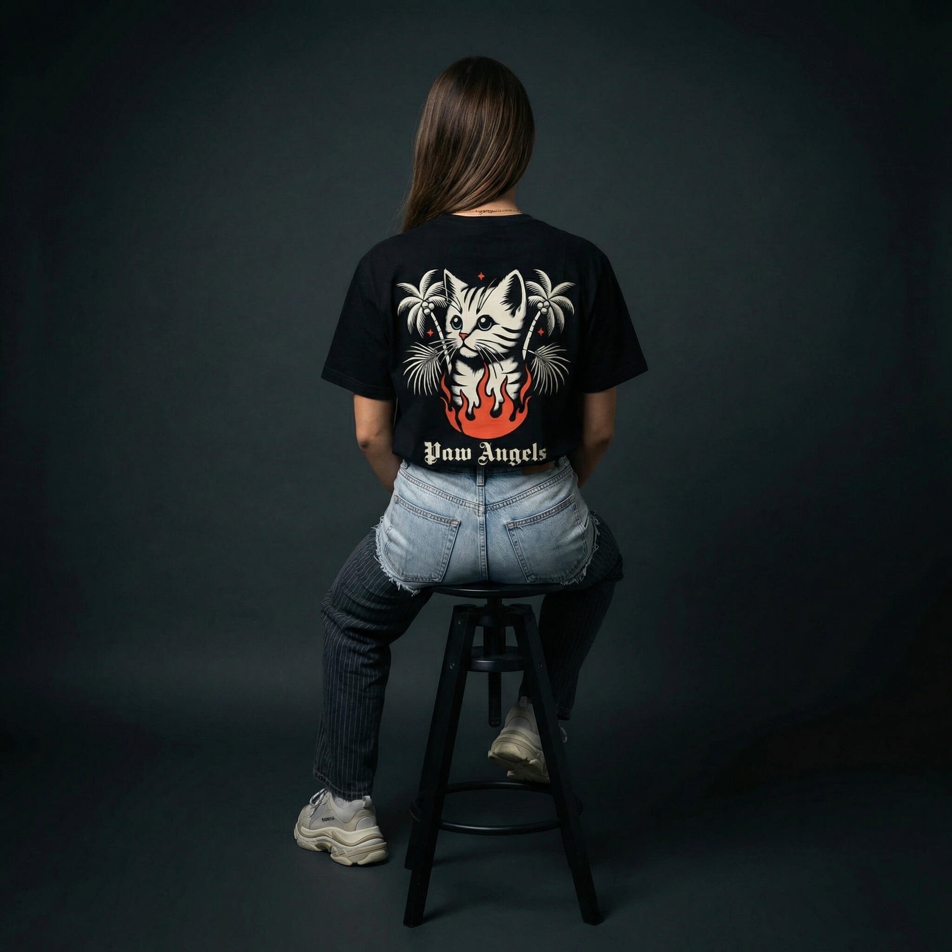 Paw Angels inferno cat tee by Mad Cat Cartel in black with back graphic and palm trees worn by woman model