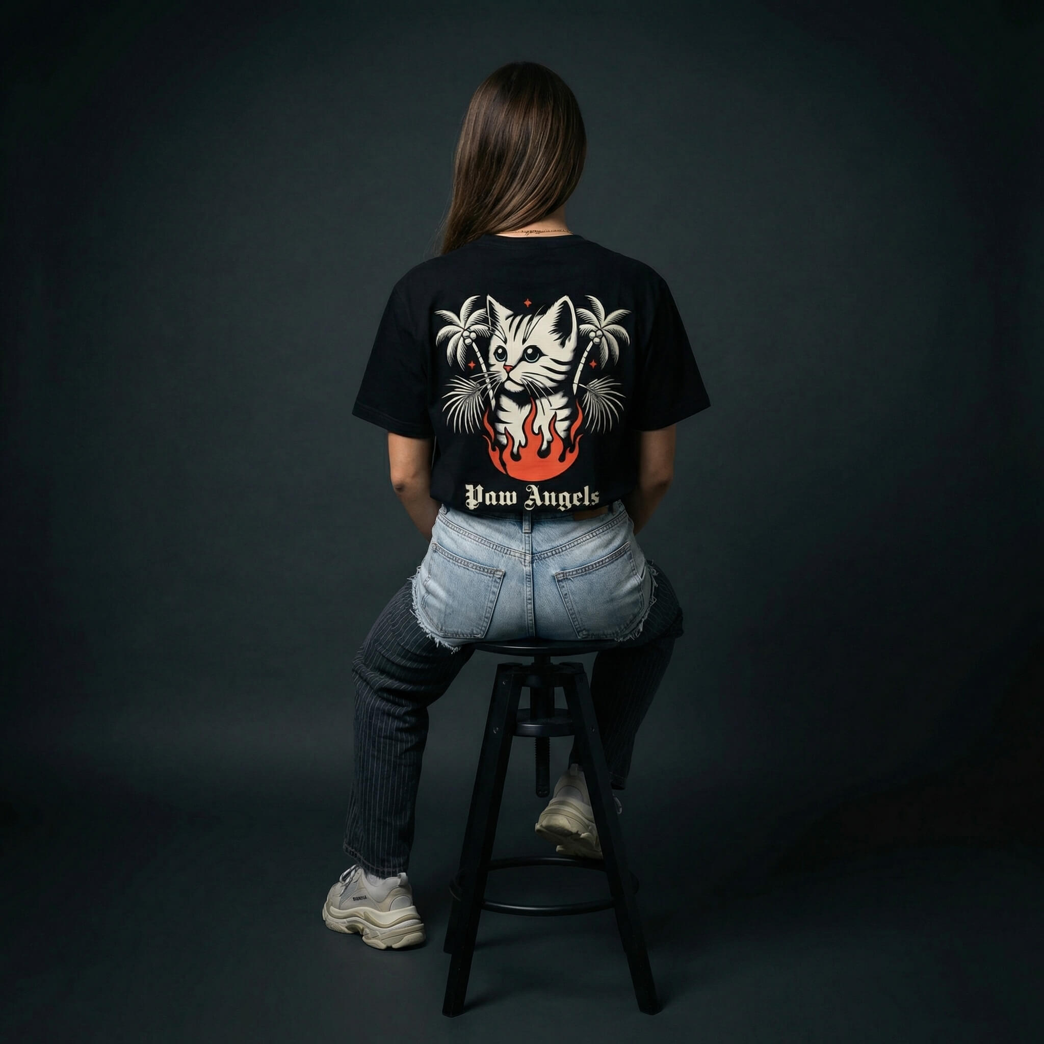 Paw Angels inferno cat tee by Mad Cat Cartel in black with back graphic and palm trees worn by woman model