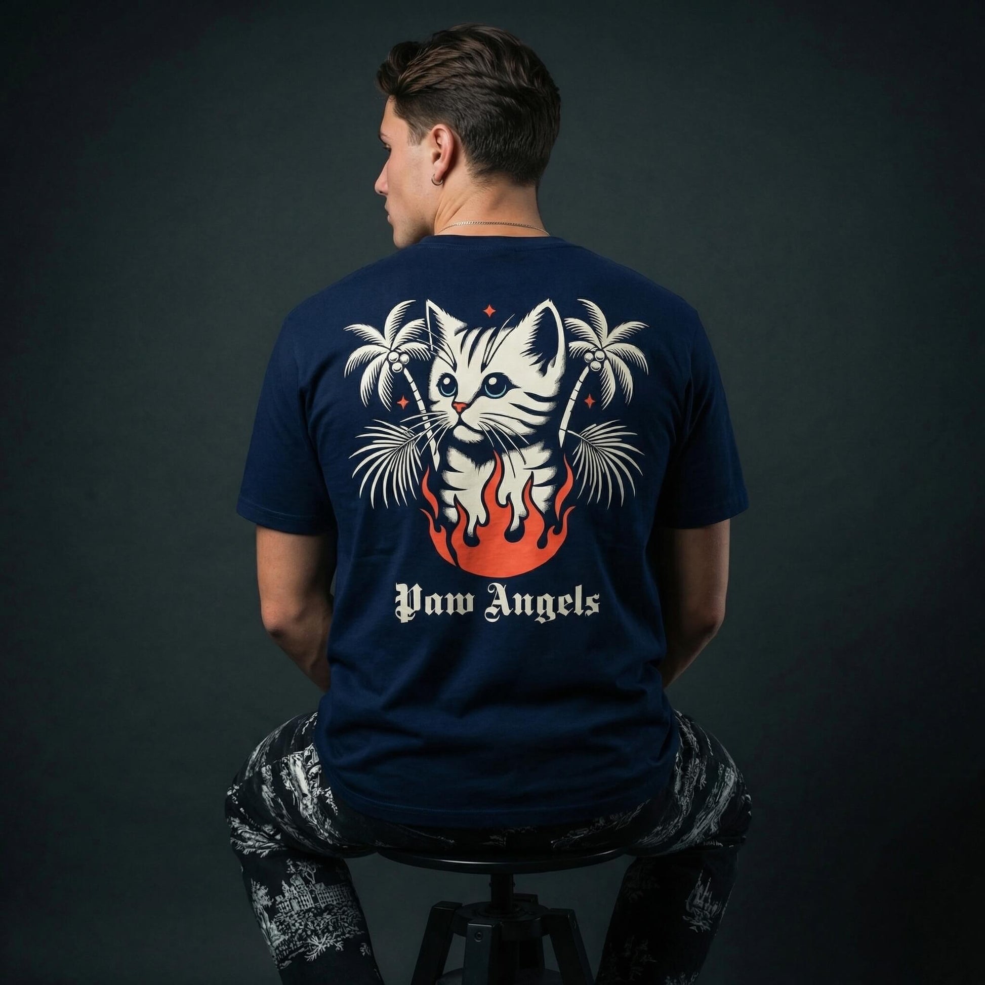 Paw Angels tropical cat graphic tee by Mad Cat Cartel in navy with back print of cat in flames worn by man model
