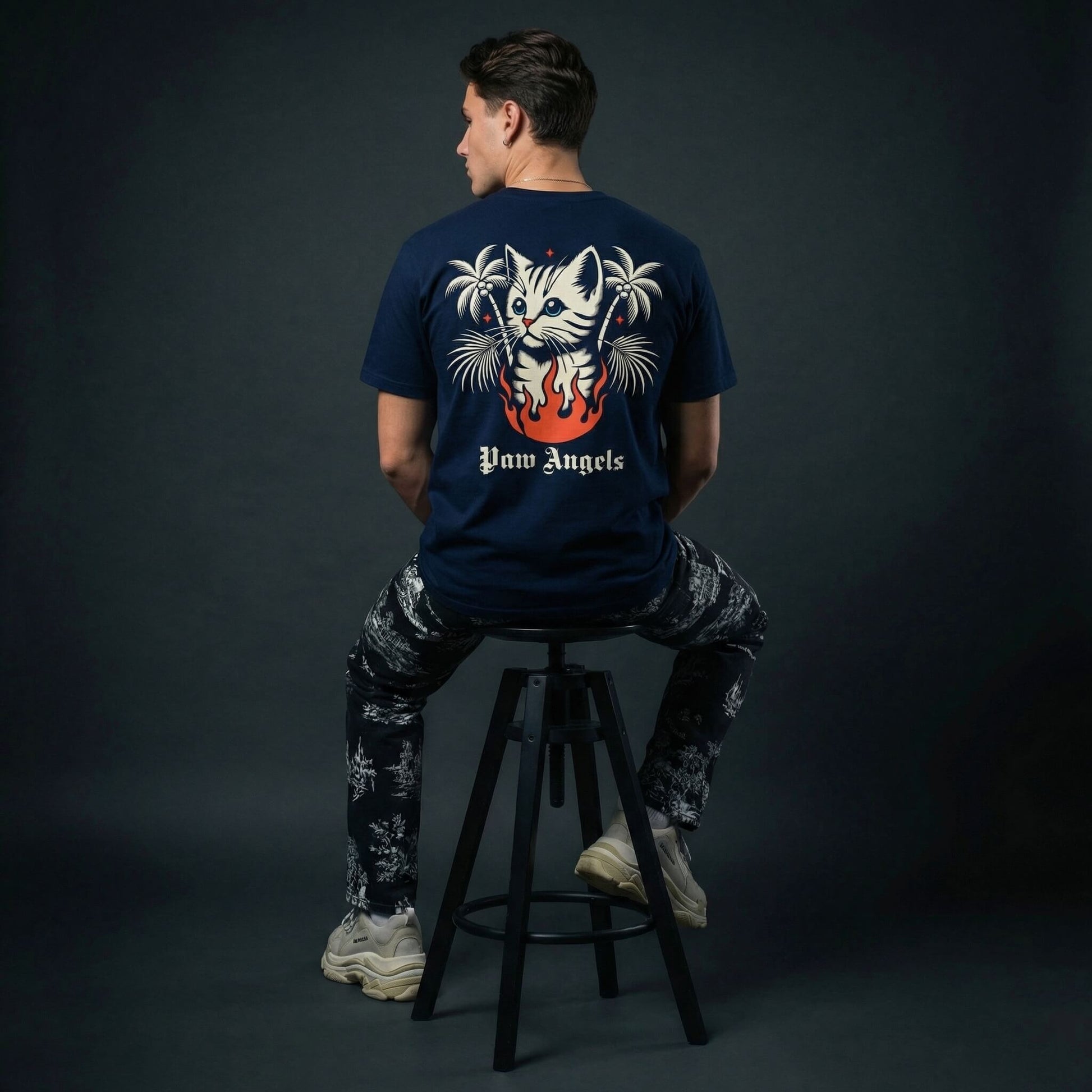 Paw Angels inferno cat t shirt by Mad Cat Cartel in navy with back graphic and palm tree flames worn by man model