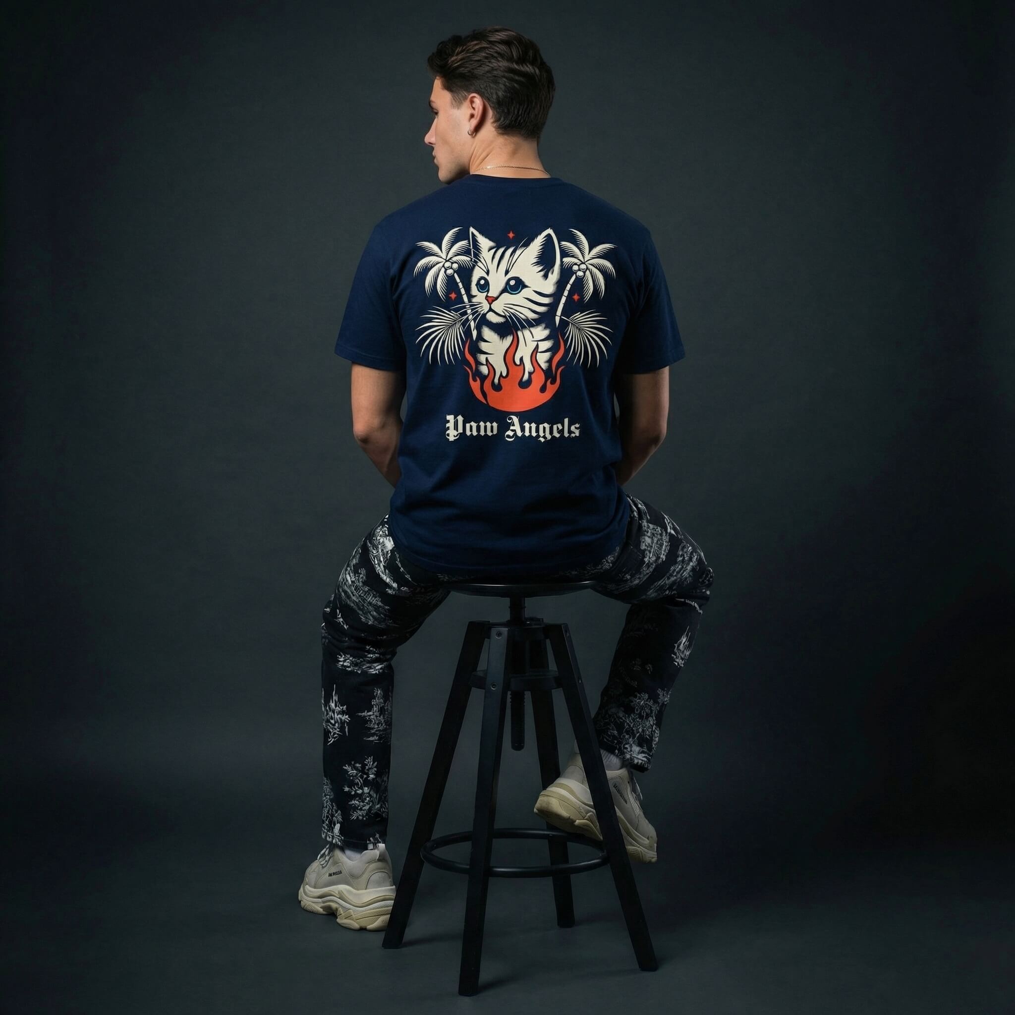 Paw Angels inferno cat t shirt by Mad Cat Cartel in navy with back graphic and palm tree flames worn by man model