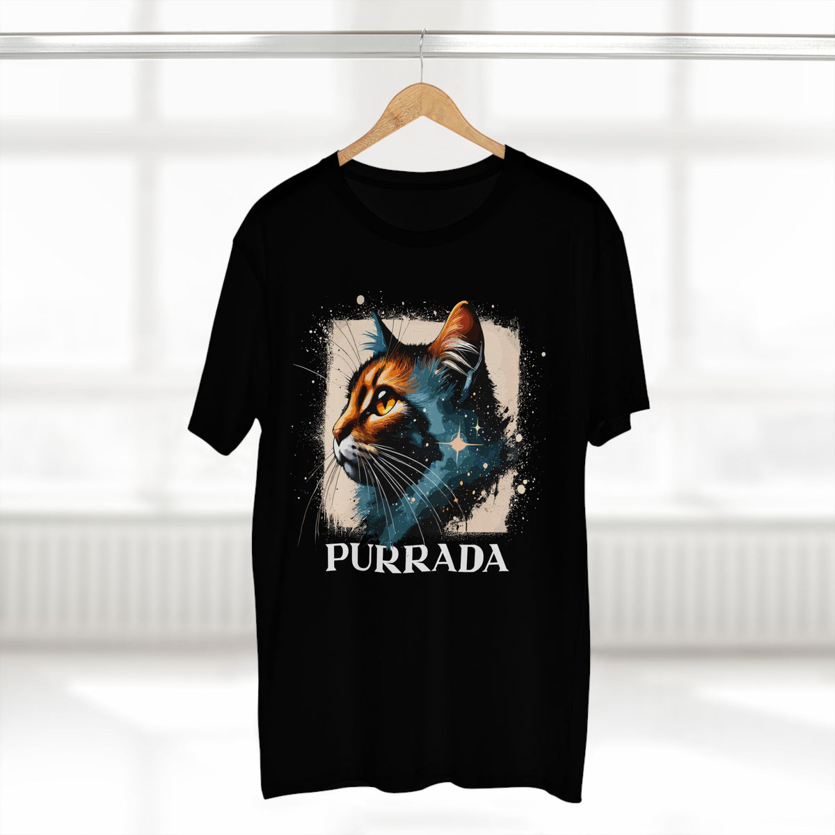 Purrada Cosmic Gaze Cat Graphic Designer T-Shirt in black, on a hanger