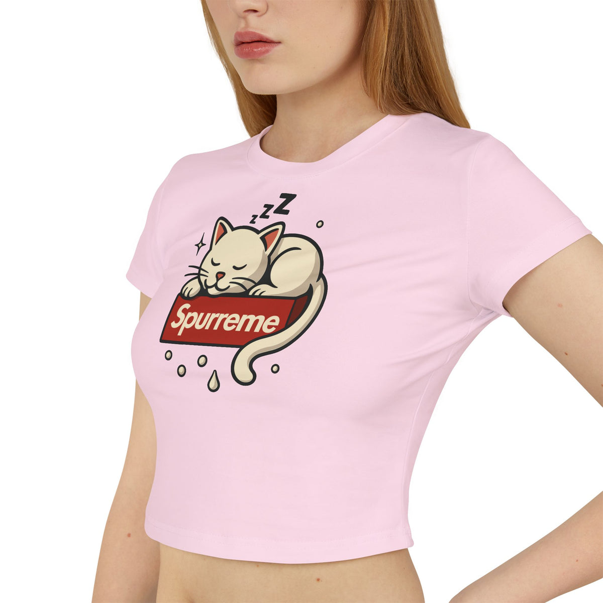 Spurreme Box Logo Dreaming Cat Graphic Women's Baby Tee in light pink, worn by a female model