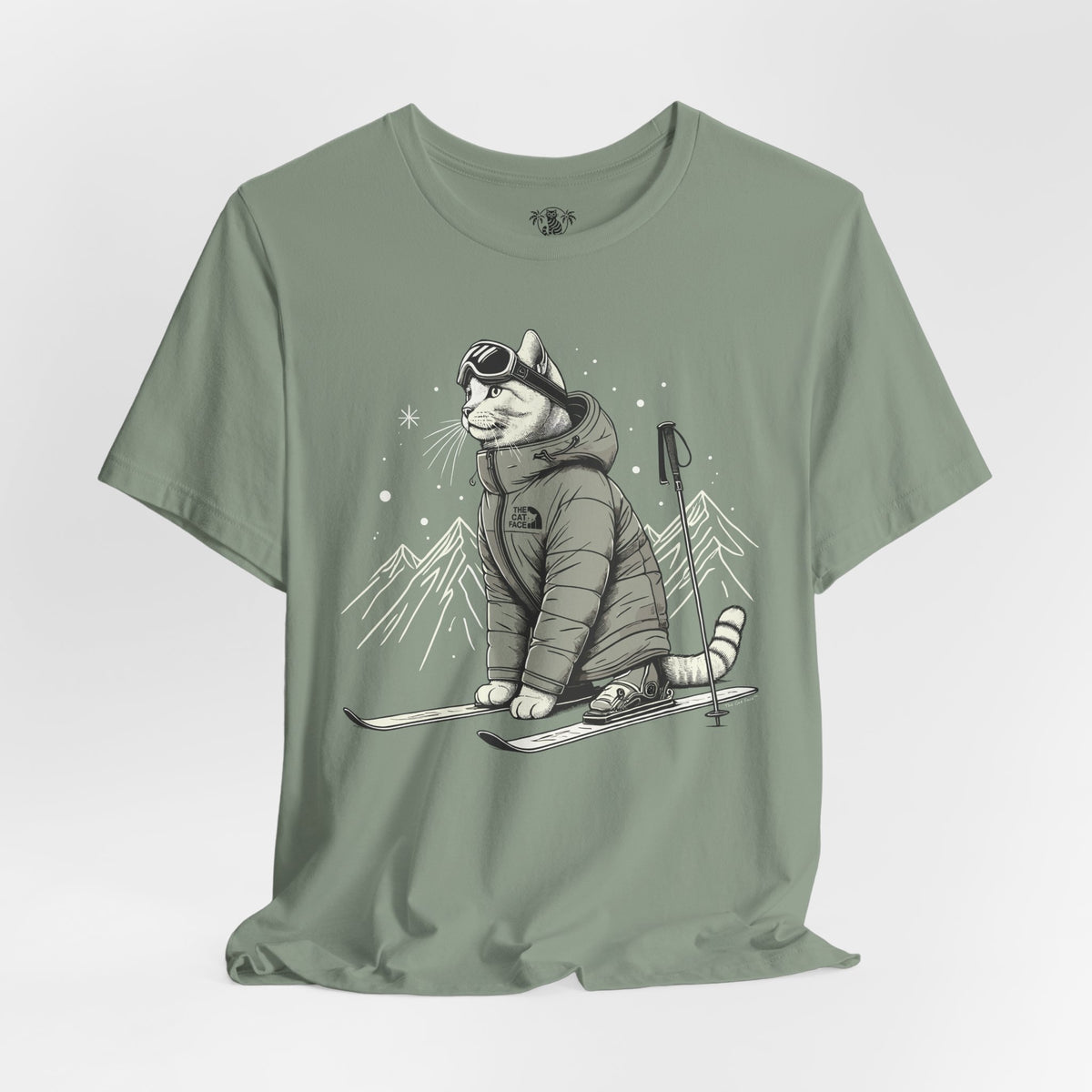 The Cat Face Alpine Explorer Graphic T-Shirt in sage, flat lay