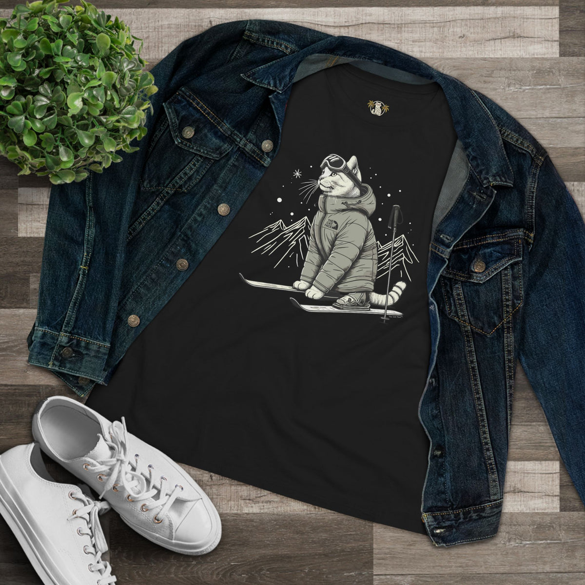 The Cat Face Alpine Explorer Graphic Women's T-Shirt in black, flat lay