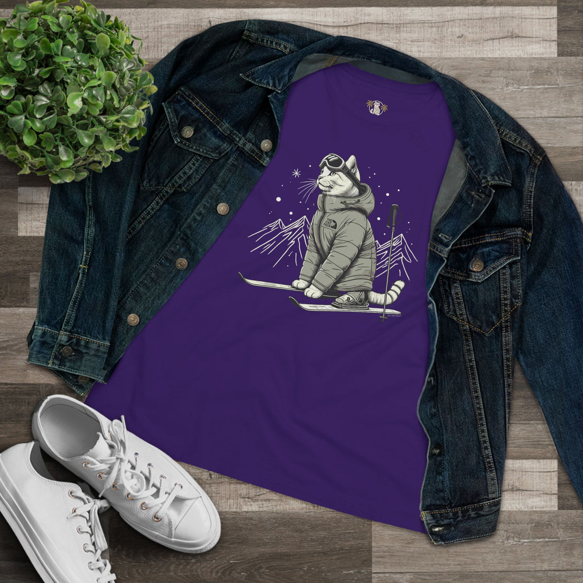 The Cat Face Alpine Explorer Graphic Women's T-Shirt in team purple, flat lay