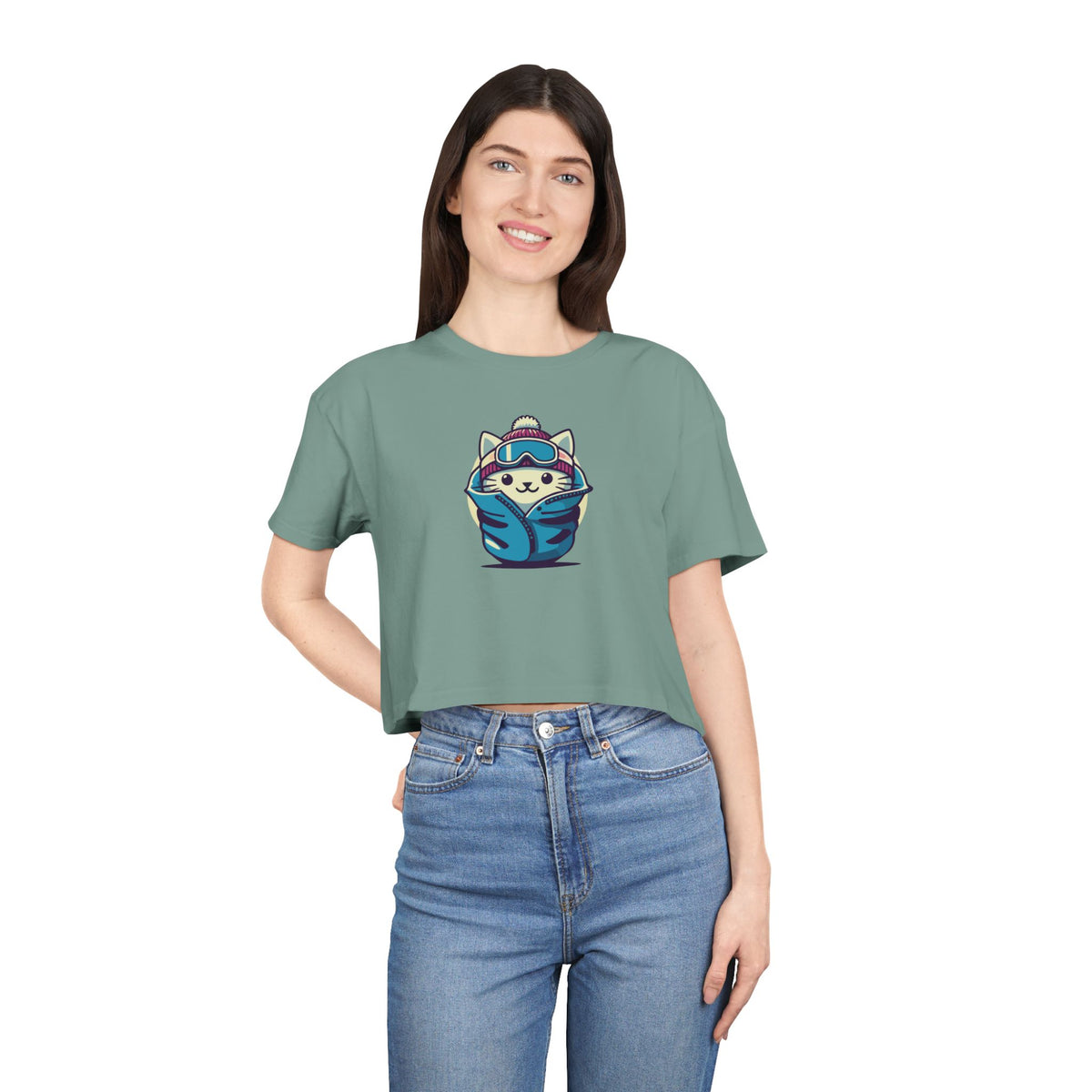 The Cat Face Apres Ski Kitty Women's Crop Top in sage, worn by a model