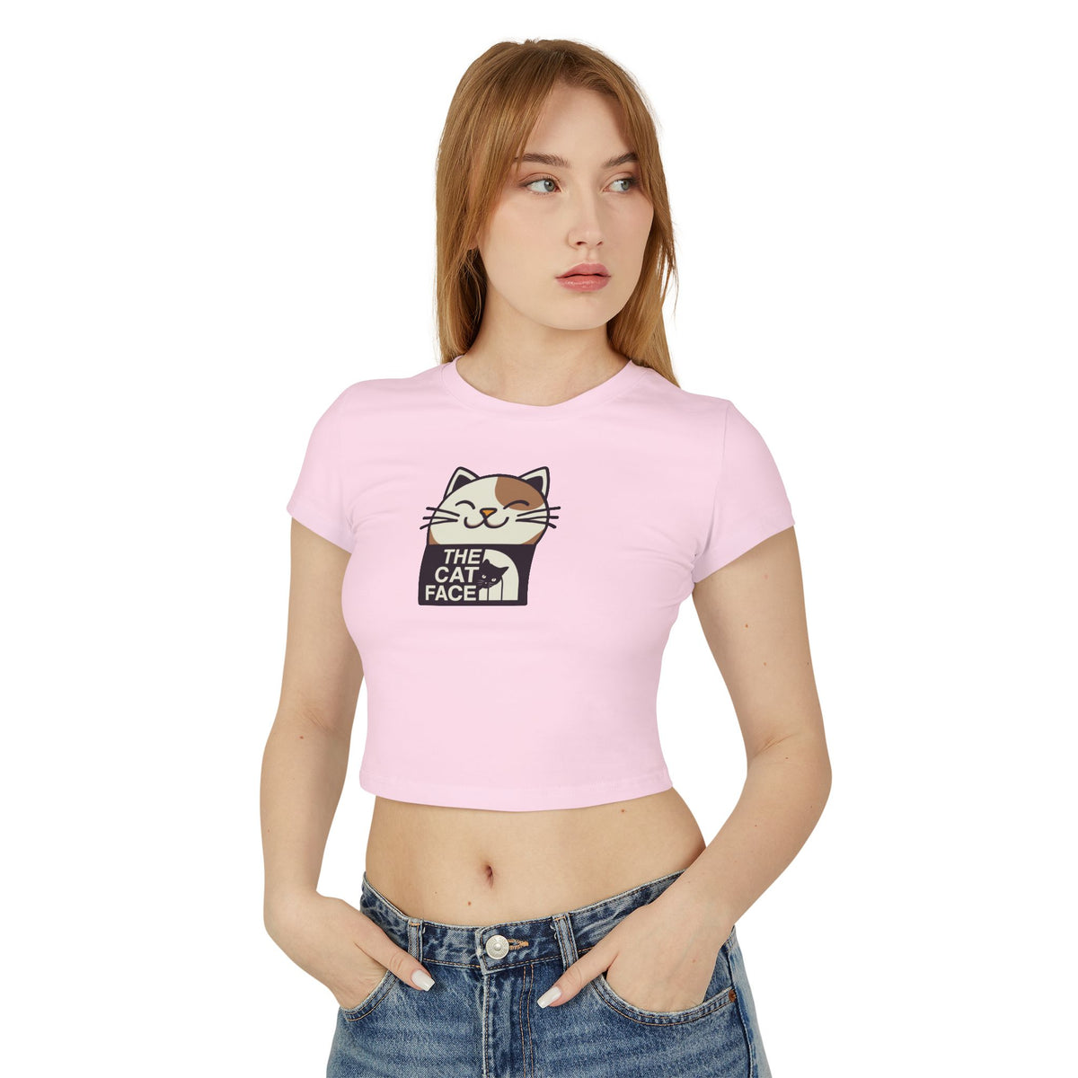 The Cat Face Bicolor Cat Icon Women's Baby Tee in light pink, worn by a model