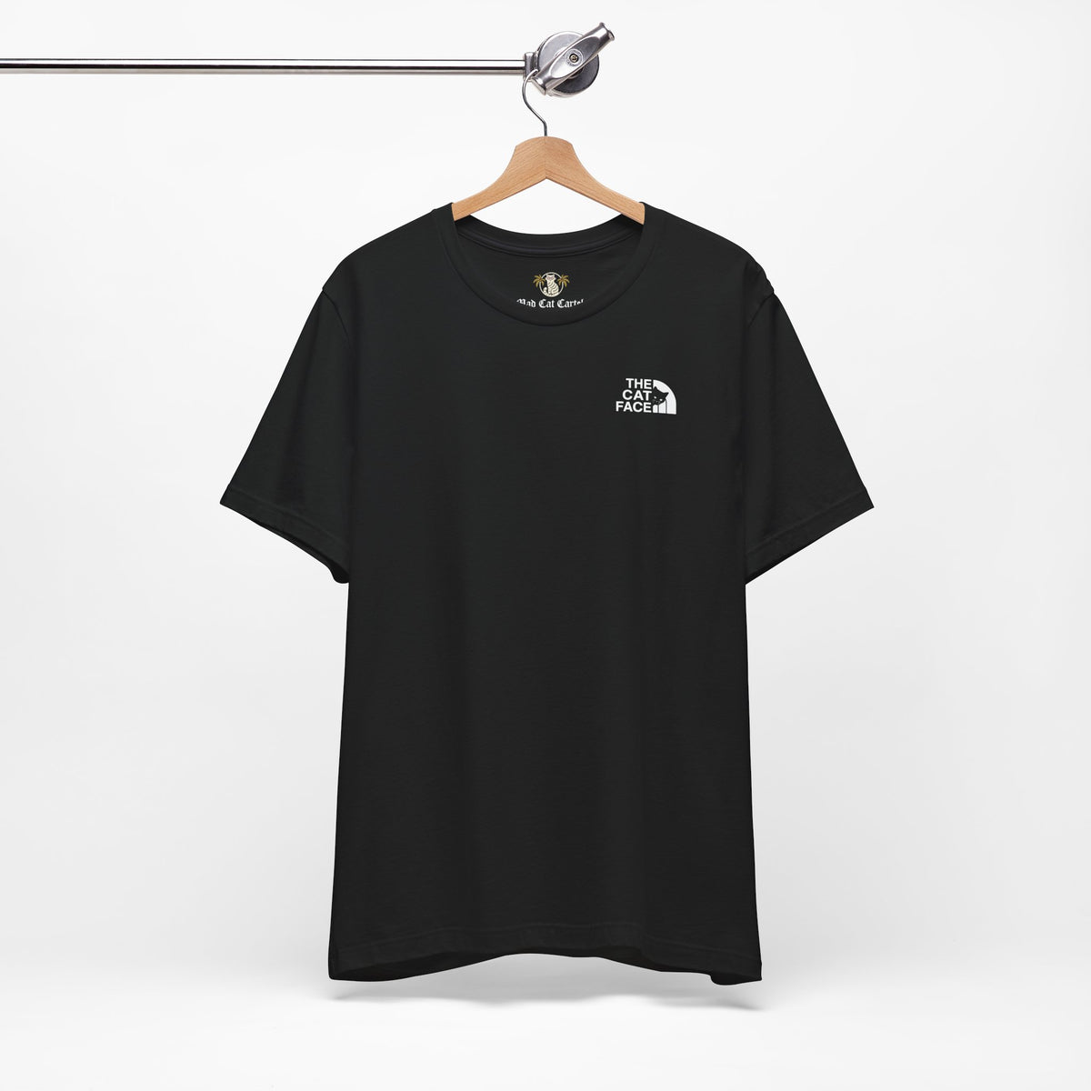 The Cat Face Classic Mini Chest Logo T-Shirt in black, on a hanger