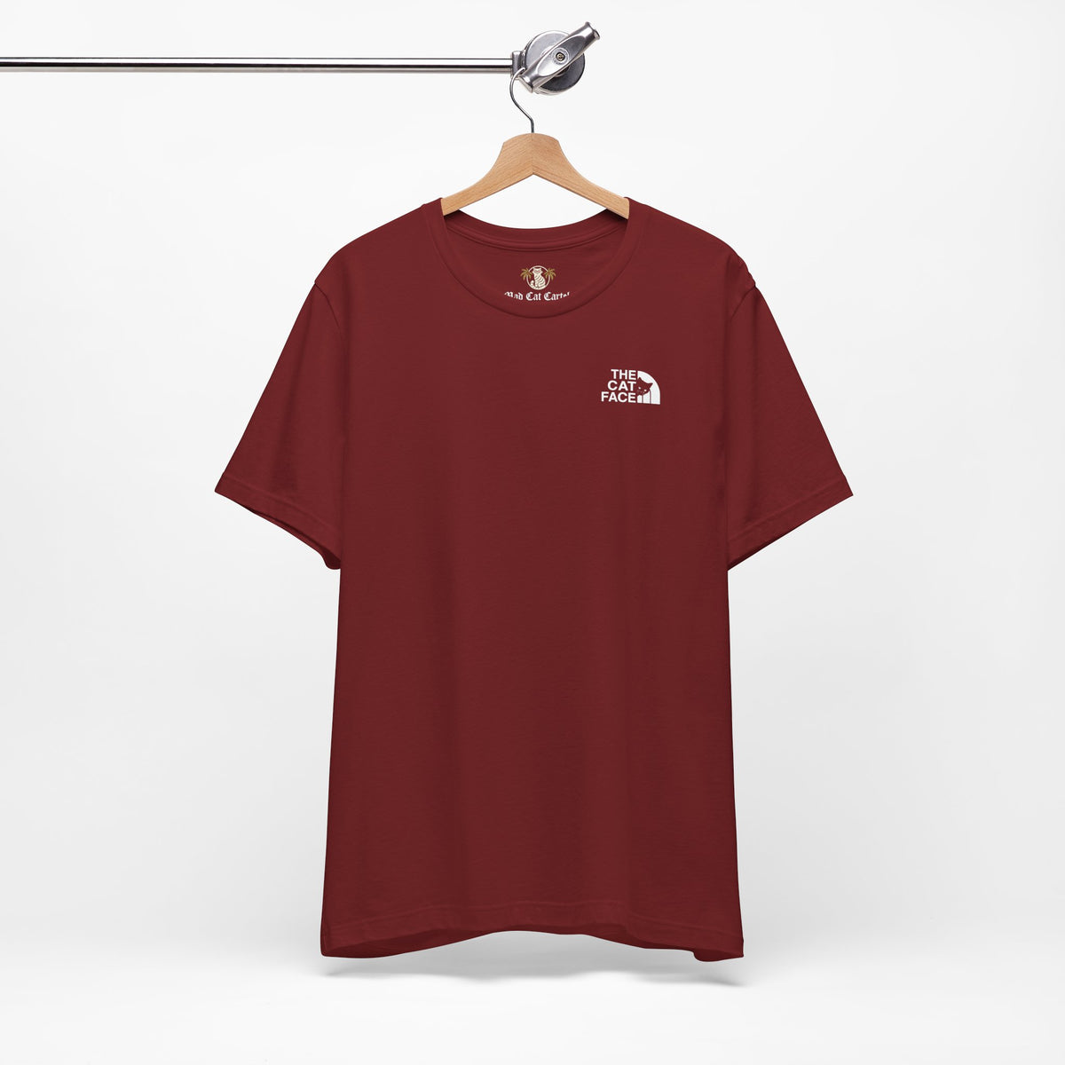 The Cat Face Classic Mini Chest Logo T-Shirt in cardinal, on a hanger