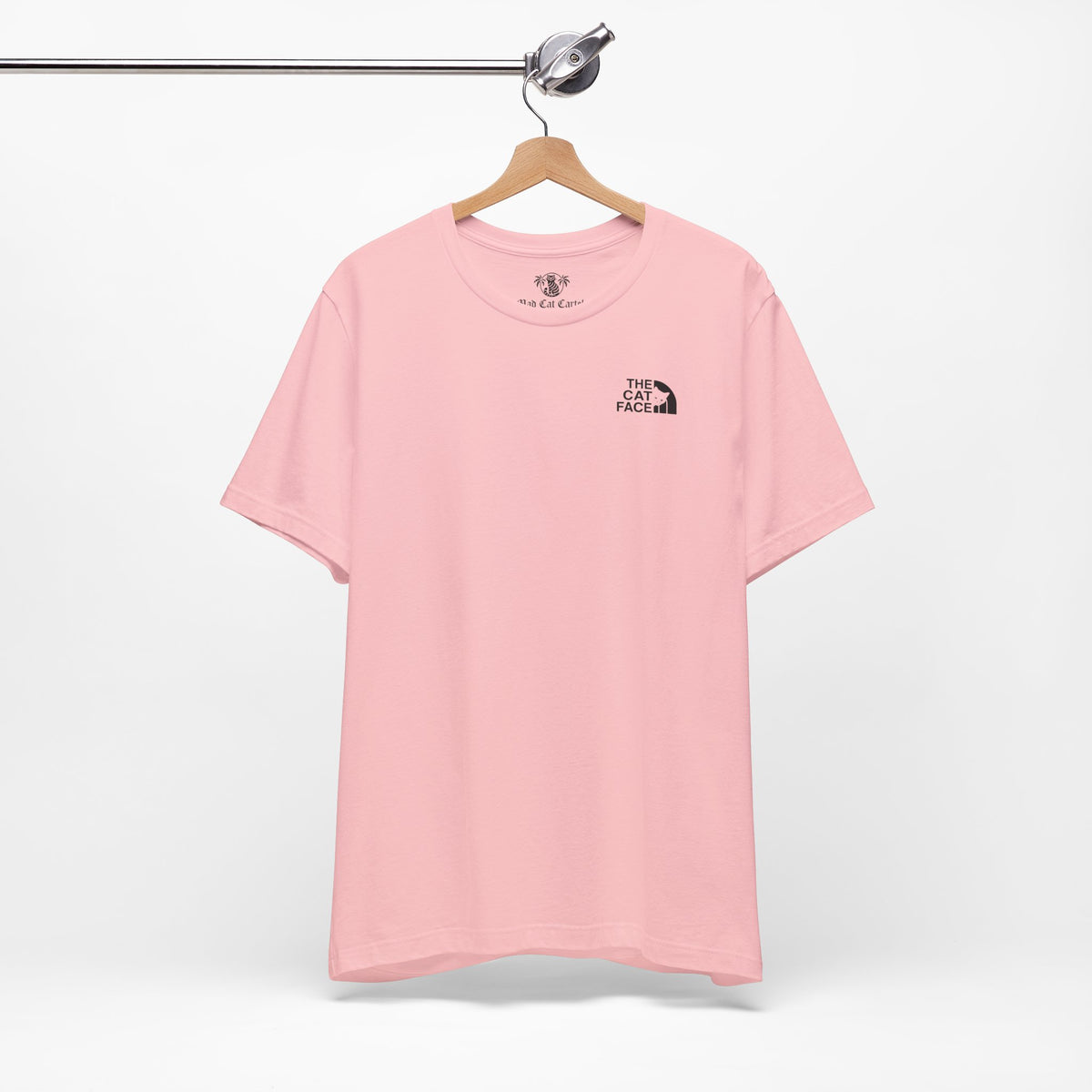 The Cat Face Classic Mini Chest Logo T-Shirt in pink, on a hanger