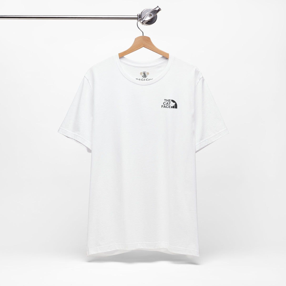 The Cat Face Classic Mini Chest Logo T-Shirt in white, on a hanger